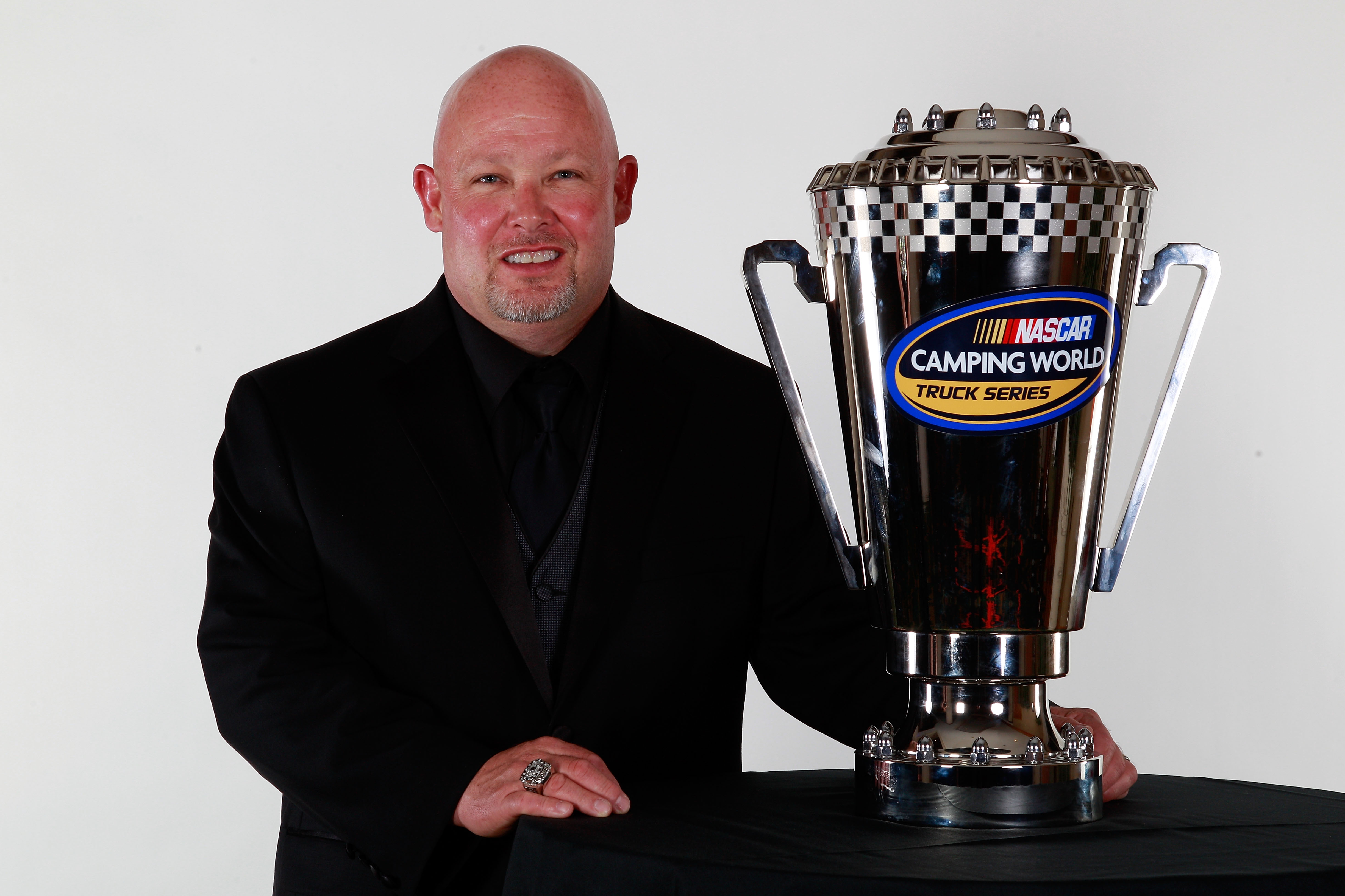 MIAMI - NOVEMBER 22:  2010 Camping World Truck Series Champion Todd Bodine, driver of the #30 Germain Racing Toyota, poses after receiving the Camping World Truck Series Champions trophy during the NASCAR Nationwide/Camping World Truck Series Banquet at L