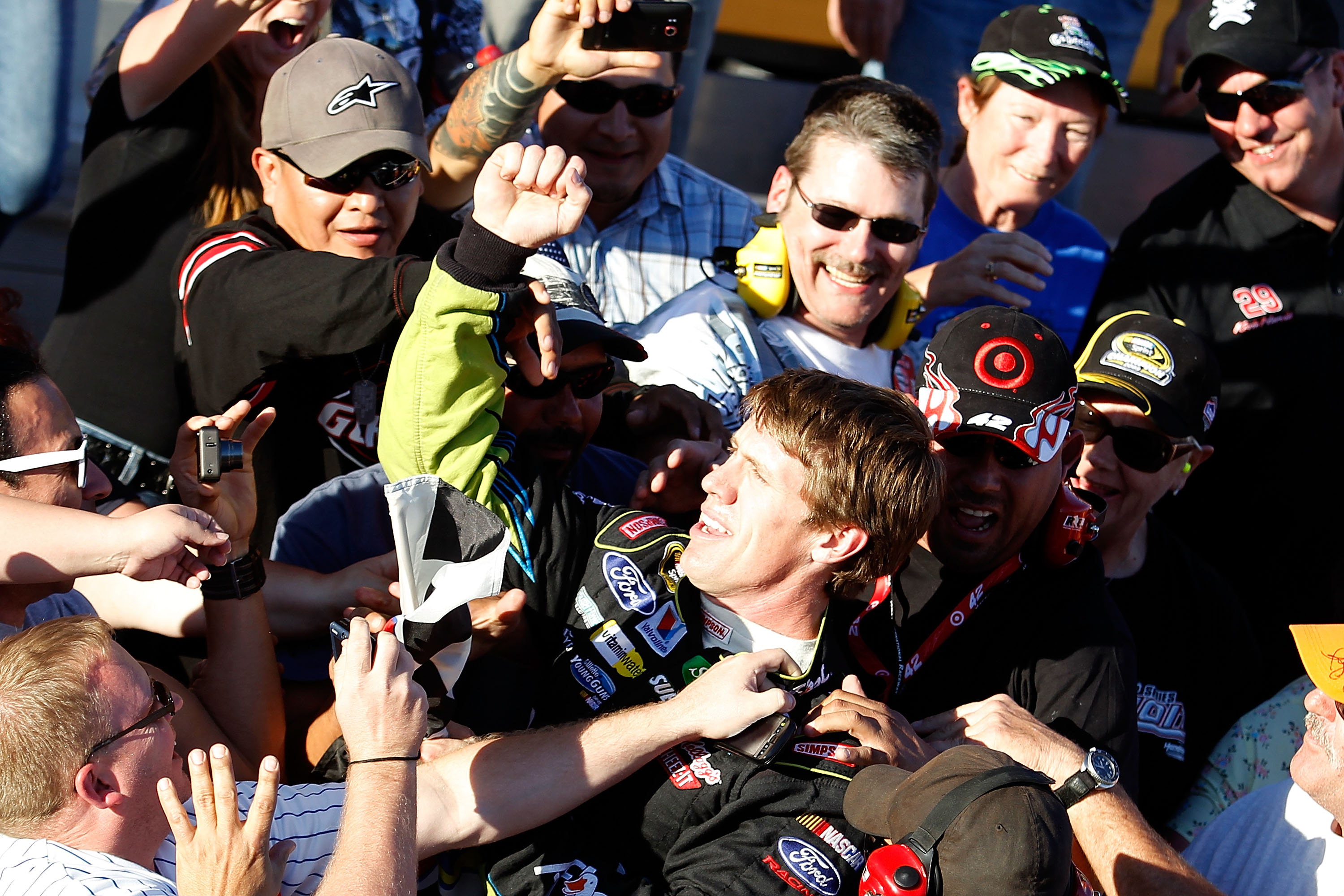 AVONDALE, AZ - NOVEMBER 14:  Carl Edwards, driver of the #99 Aflac Ford, celebrates in the stands with fans after winning the NASCAR Sprint Cup Series Kobalt Tools 500 at Phoenix International Raceway on November 14, 2010 in Avondale, Arizona.  (Photo by