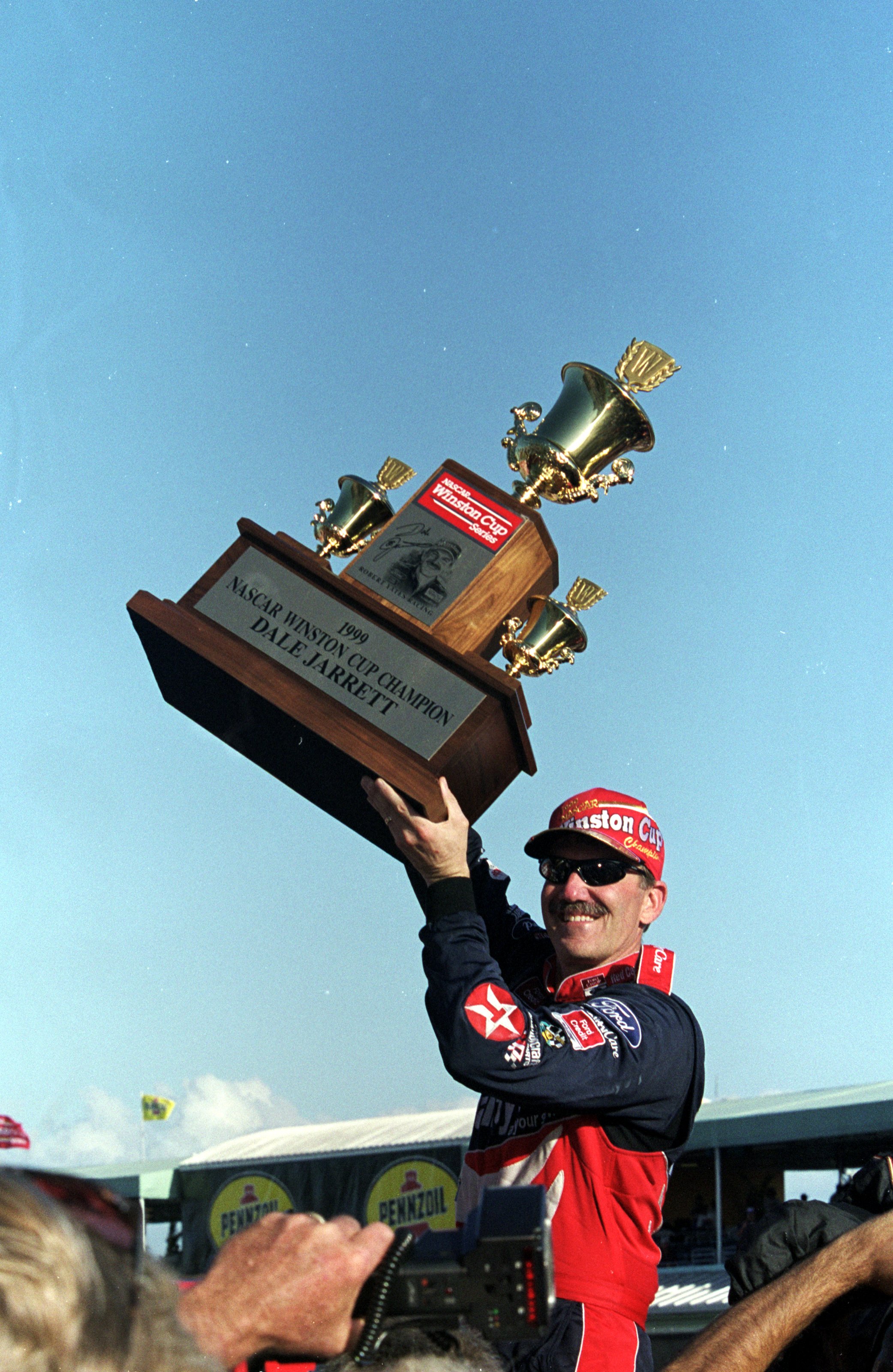 14 Nov 1999:  Dale Jarrett smiles and holds up his trophy after winning  the Pennzoil 400, part of the NASCAR Winston Cup Series, at the Homestead - Miami Speedway in Homestead, Florida. Mandatory Credit: Jon Ferrey  /Allsport