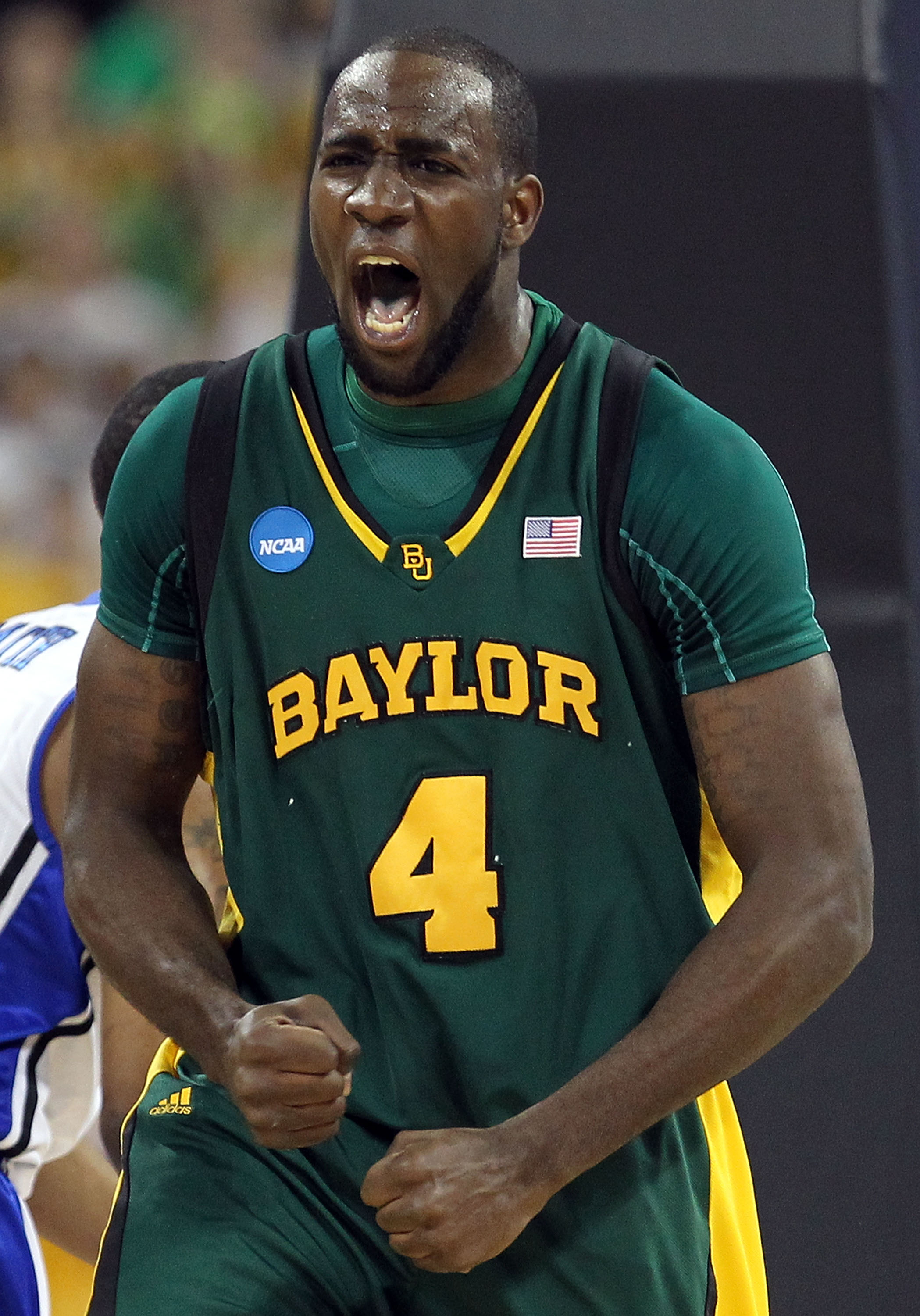 HOUSTON - MARCH 28:  Forward Quincy Acy #4 of the Baylor Bears reacts after making a slam dunk against the Duke Blue Devils during the south regional final of the 2010 NCAA men's basketball tournament at Reliant Stadium on March 28, 2010 in Houston, Texas