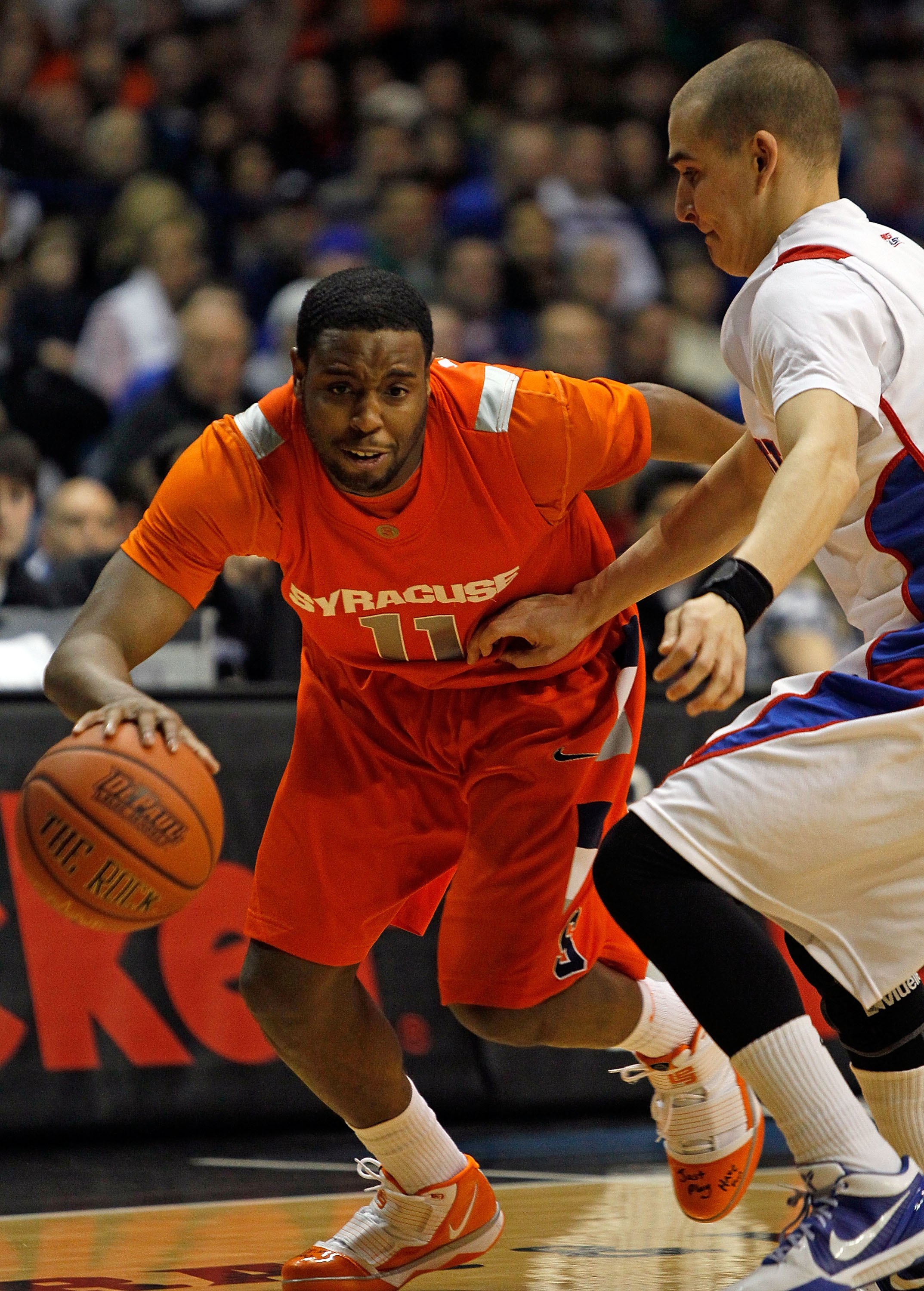 ROSEMONT, IL - JANUARY 30: Scoop Jardine #11 of the Syracuse Orange moves against Michael Bizoukas #0 of the DePaul Blue Demons at the Allstate Arena on January 30, 2010 in Rosemont, Illinois. Syracuse defeated DePaul 59-57. (Photo by Jonathan Daniel/Gett
