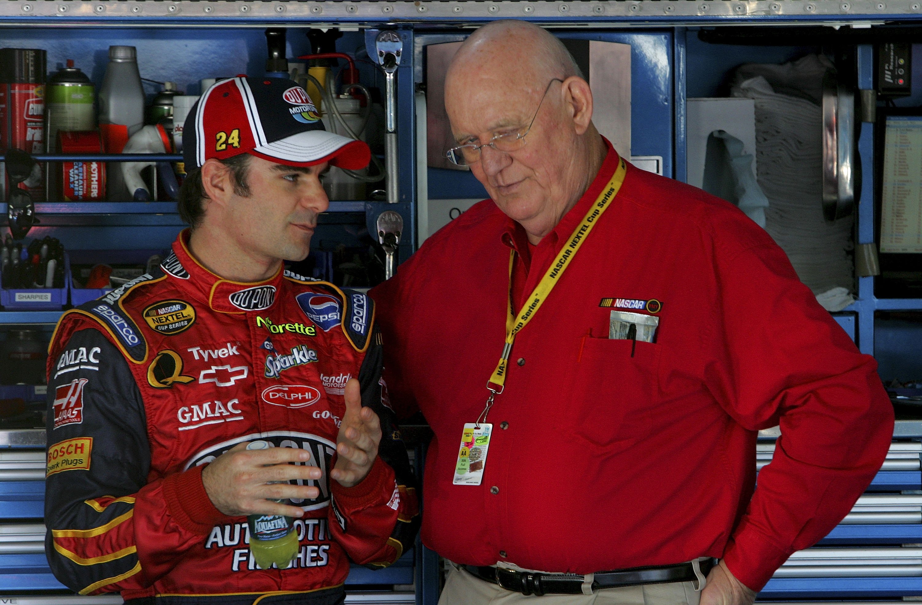 CONCORD, NC - OCTOBER 13:  Jeff Gordon, driver of the #24 DuPont Chevrolet, talks with TV Analyst Benny Parsons, in the garage, during practice for the NASCAR Nextel Cup Series Bank of America 500 on October 13, 2006 at Lowe's Motor Speedway in Concord, N