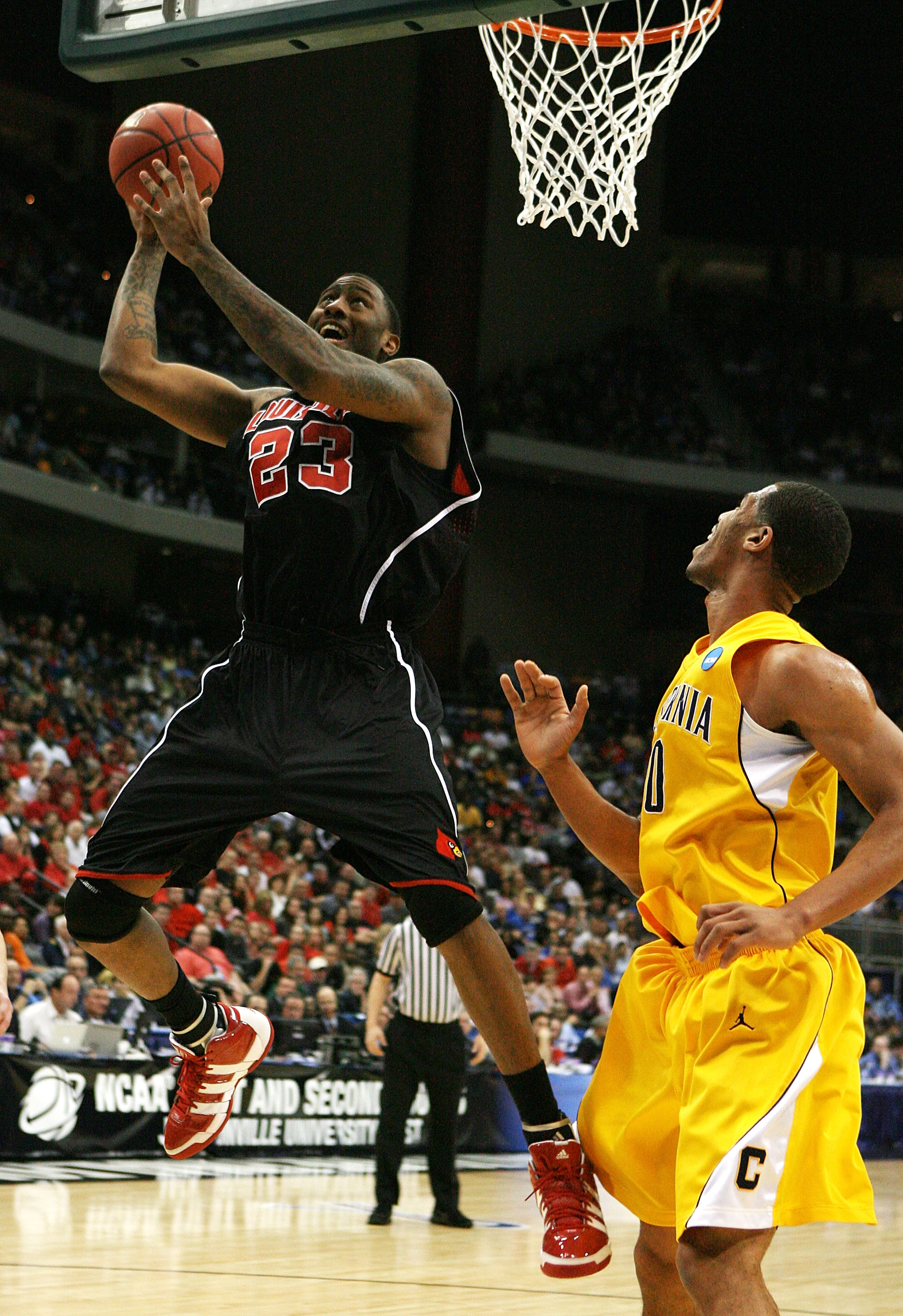 JACKSONVILLE, FL - MARCH 19:  Terrence Jennings #23 of the Louisville Cardinals scores over Jamal Boykin #10 of the California Golden Bears during the first round of the 2010 NCAA men's basketball tournament at Jacksonville Veteran's Memorial Arena on Mar