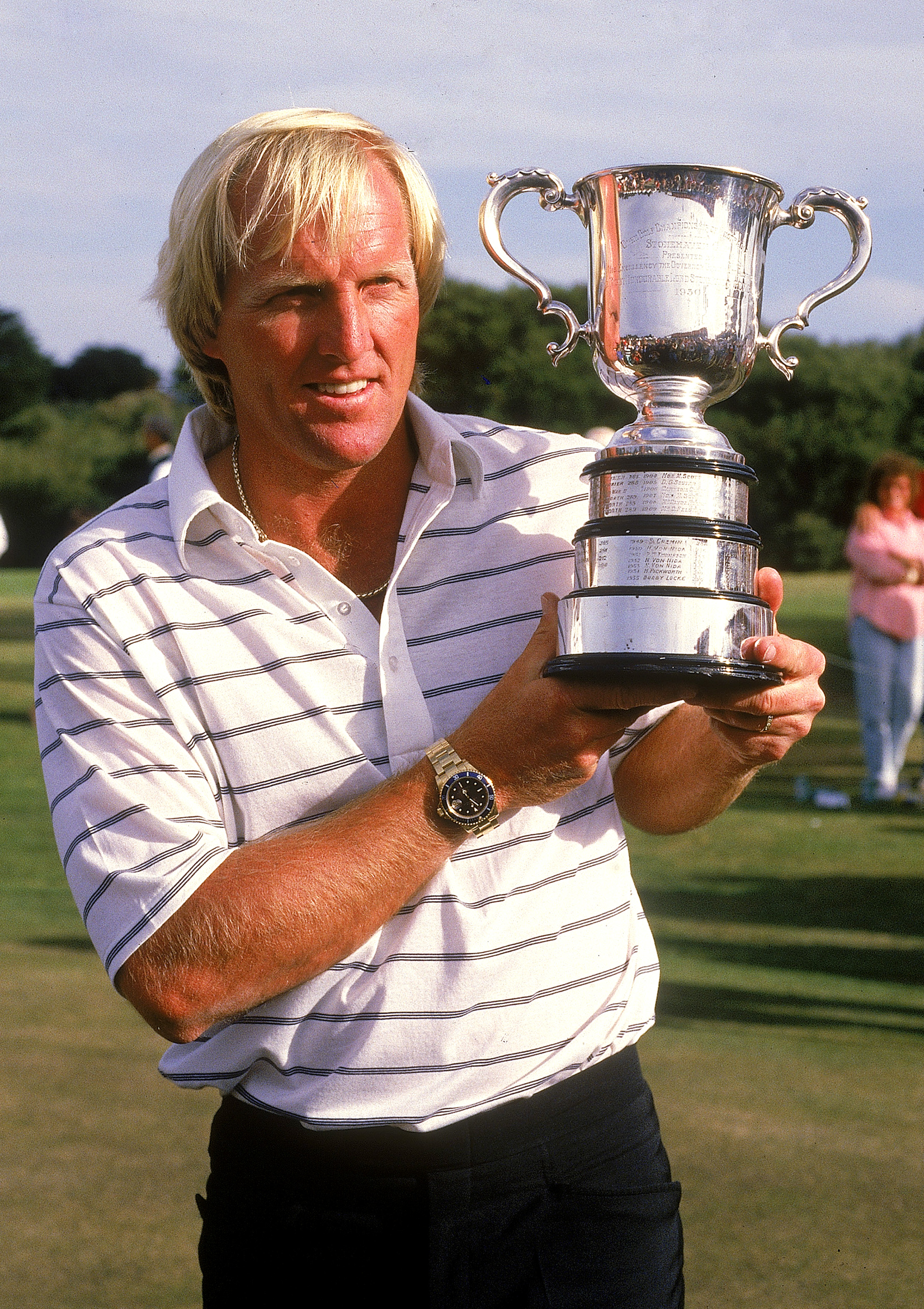 Vijay Singh of Fiji holds the championship trophy with Mickey