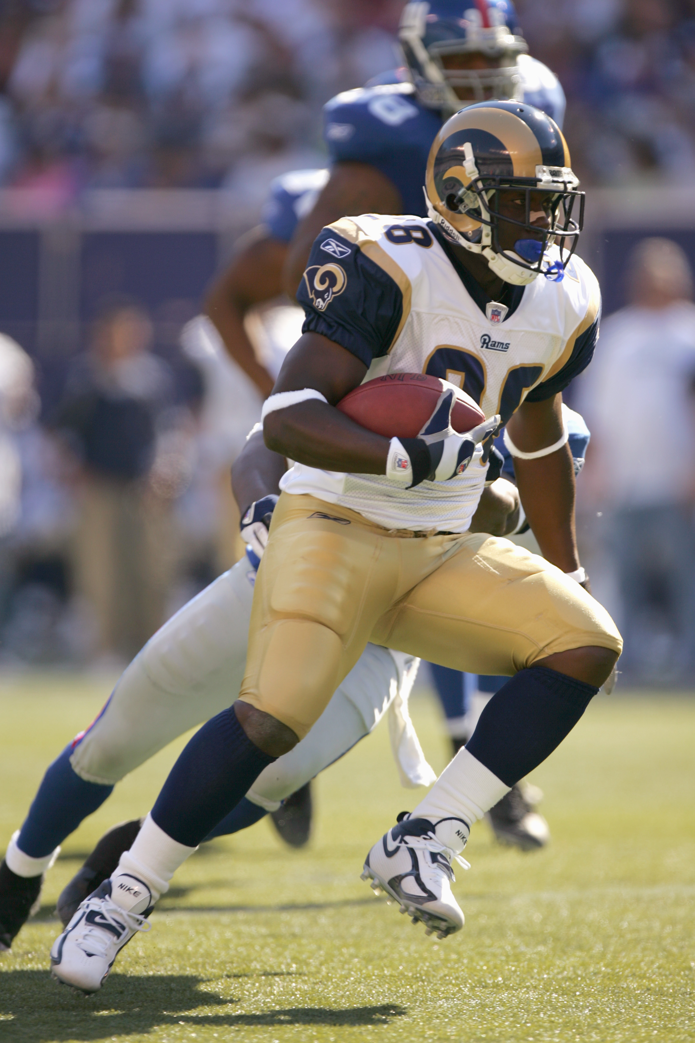EAST RUTHERFORD, NJ - OCTOBER 02: Marshall Faulk #28 of the St. Louis Rams carries the ball during the game against the New York Giants on October 2, 2005 at Giants Stadium in East Rutherford, New Jersey. The Giants won 44-24. (Photo by Ezra Shaw/Getty Im