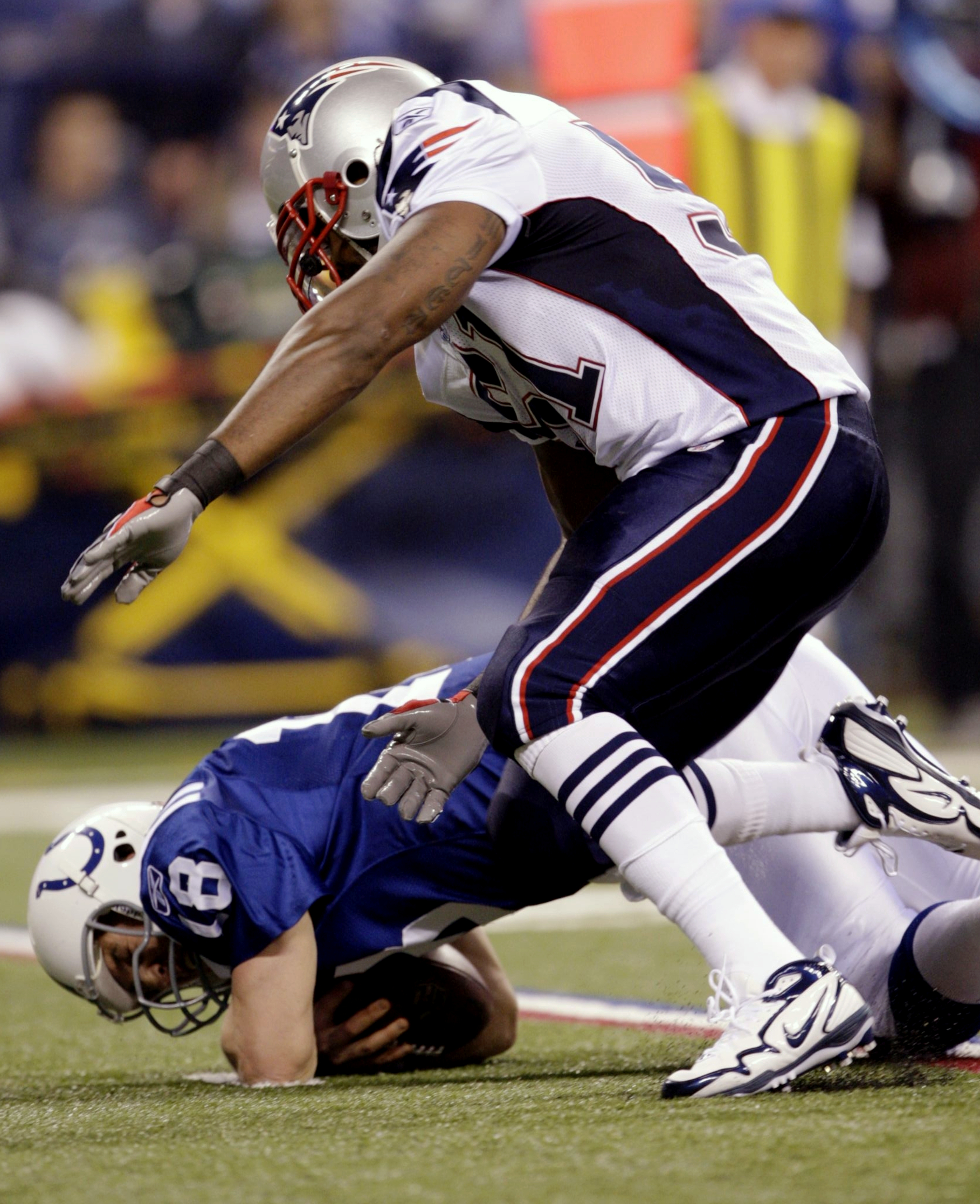 INDIANAPOLIS - NOVEMBER 15: Quarterback Peyton Manning #18 of the Indianapolis Colts is sacked by Jerod Mayo #51 of the New England Patriots during the second quarter of the game at Lucas Oil Stadium on November 15, 2009 in Indianapolis, Indiana. (Photo b