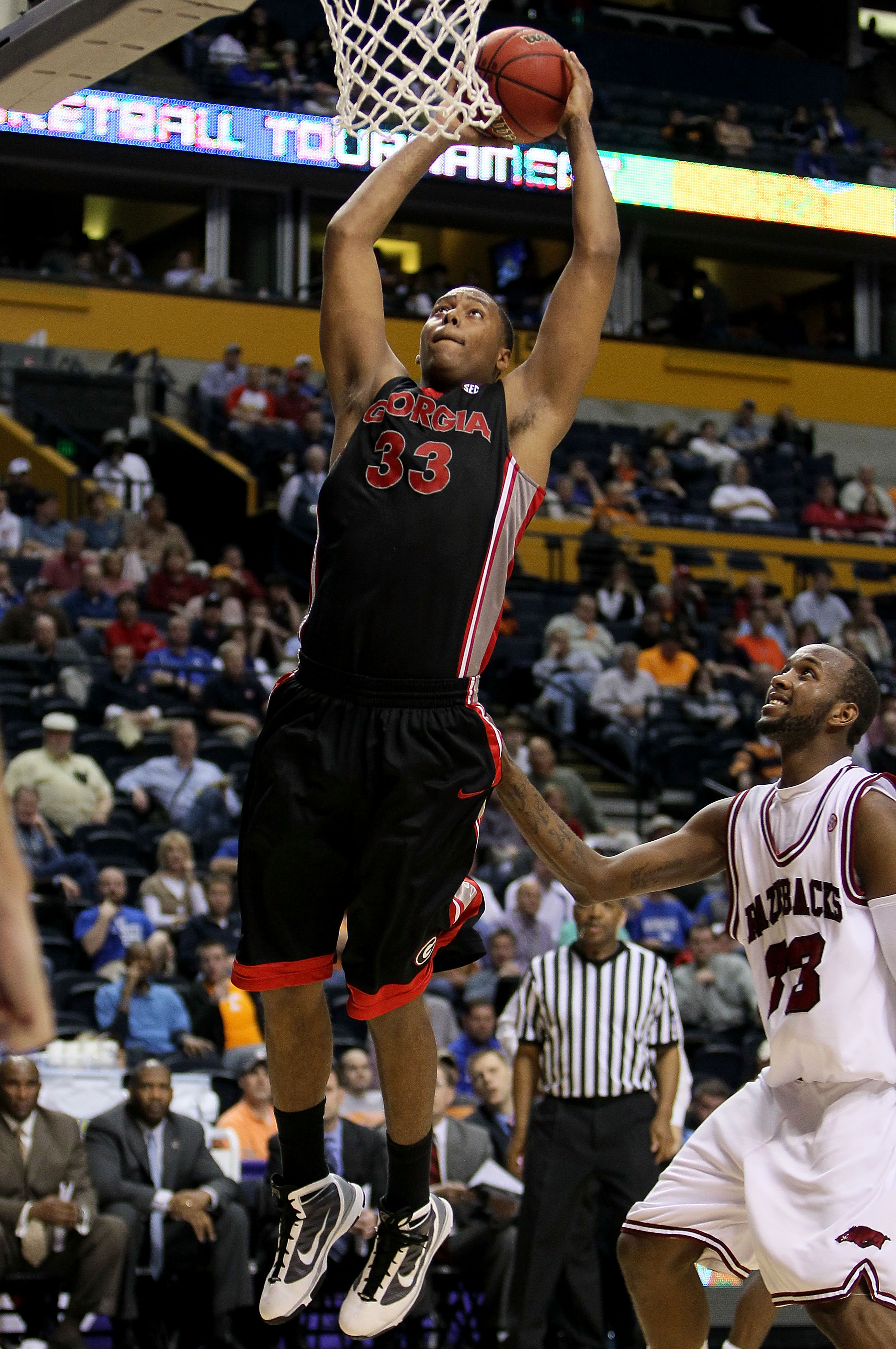 NASHVILLE, TN - MARCH 11:  Trey Thompkins #33 of the Georgia Bulldogs goes up for a dunk attempt against the Arkanasas Razorbacks during the first round of the SEC Men's Basketball Tournament at the Bridgestone Arena on March 11, 2010 in Nashville, Tennes