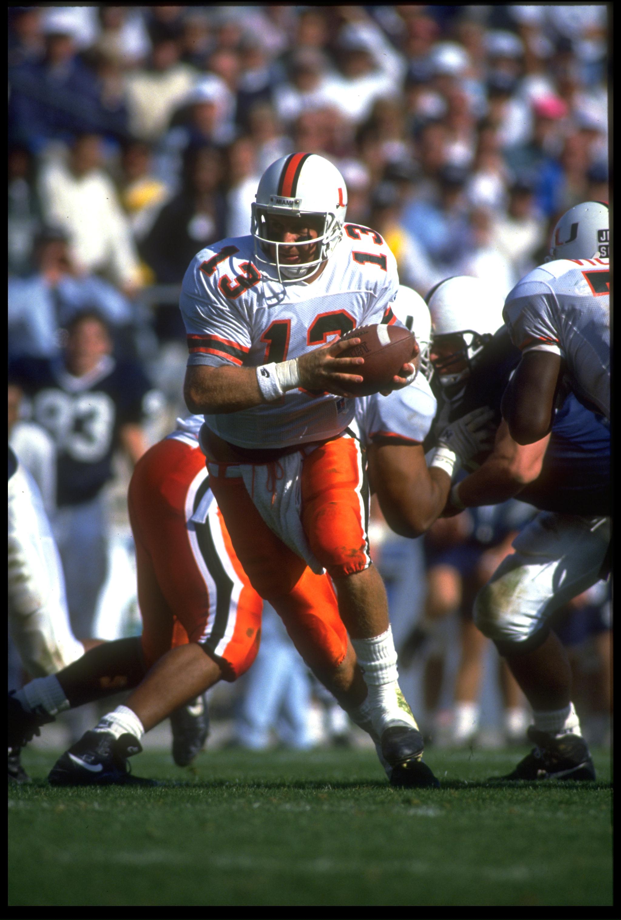10 Oct 1992: UNIVERSITY OF MIAMI QUARTERBACK GINO TORRETTA LOOKS TO HAND OFF DURING THE HURRICANES 17-14 WIN OVER THE PENN STATE NITTANY LIONS AT BEAVER STADIUM IN UNIVERSITY PARK, PENNSYLVANIA