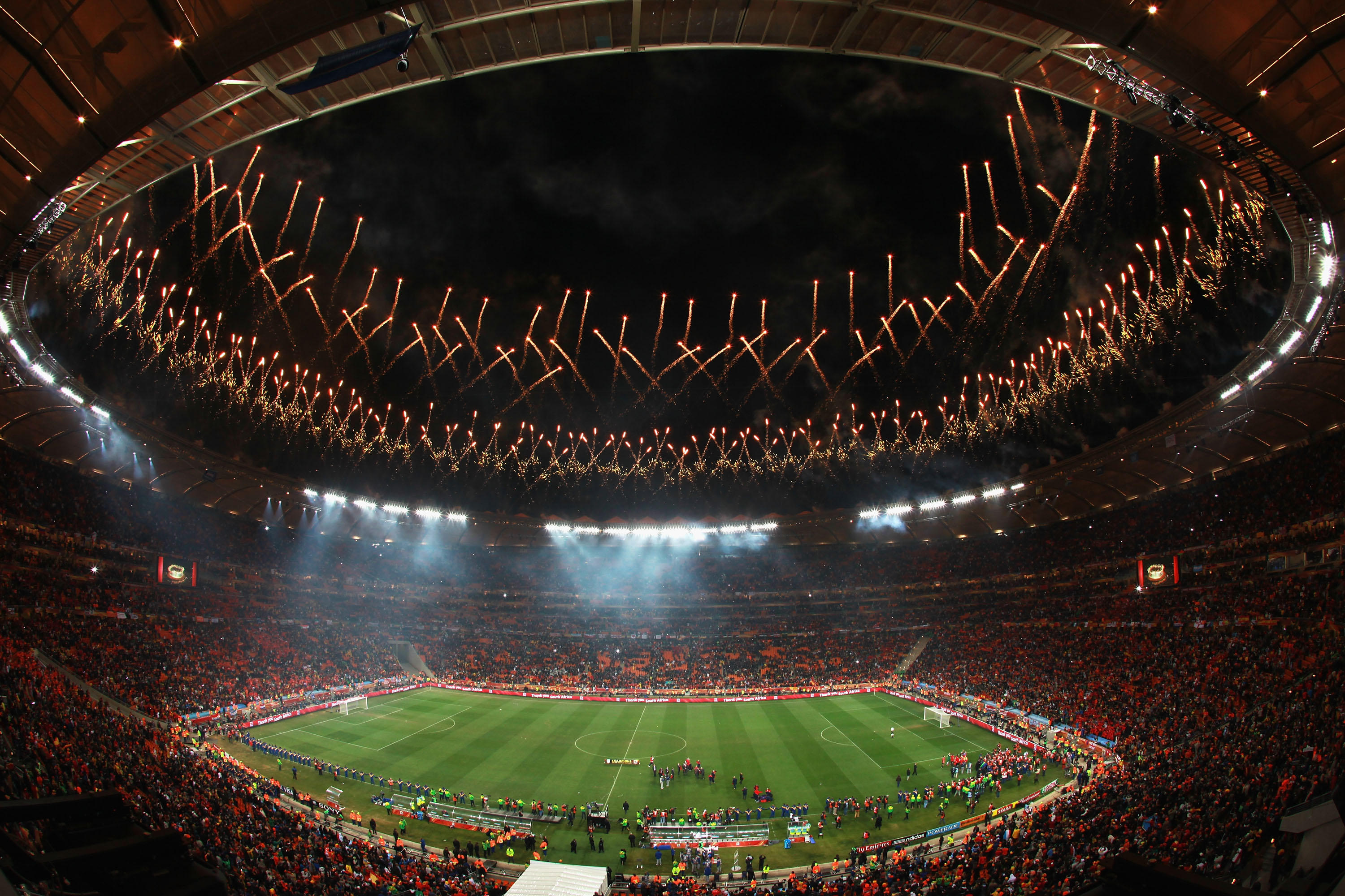 JOHANNESBURG, SOUTH AFRICA - JULY 11:  Fireworks explode as the Spain team celebrate victory with the World Cup trophy following the 2010 FIFA World Cup South Africa Final match between Netherlands and Spain at Soccer City Stadium on July 11, 2010 in Joha