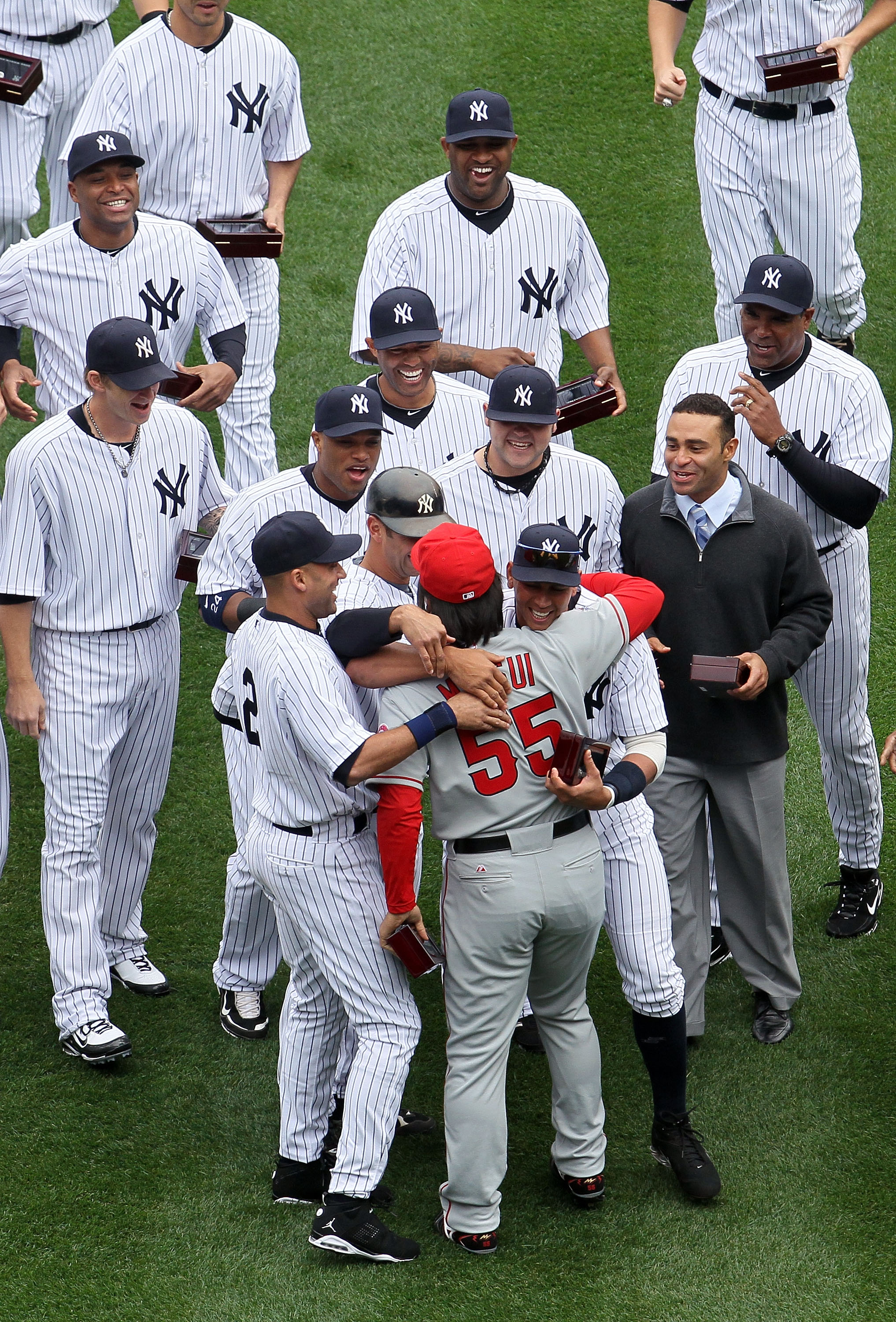 NEW YORK - APRIL 13:  Hideki Matsui #55 of the Los Angeles Angels of Anaheim is greeted by former teammates Alex Rodriguez #13, Derek Jeter #2, Jorge Posada #20, Robinson Cano #24, Joba Chamberlain #62 and Mariano Rivera #42 of the New York Yankees after