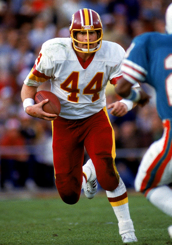 Washington Redskins' full back John Riggins (44) is slowed down