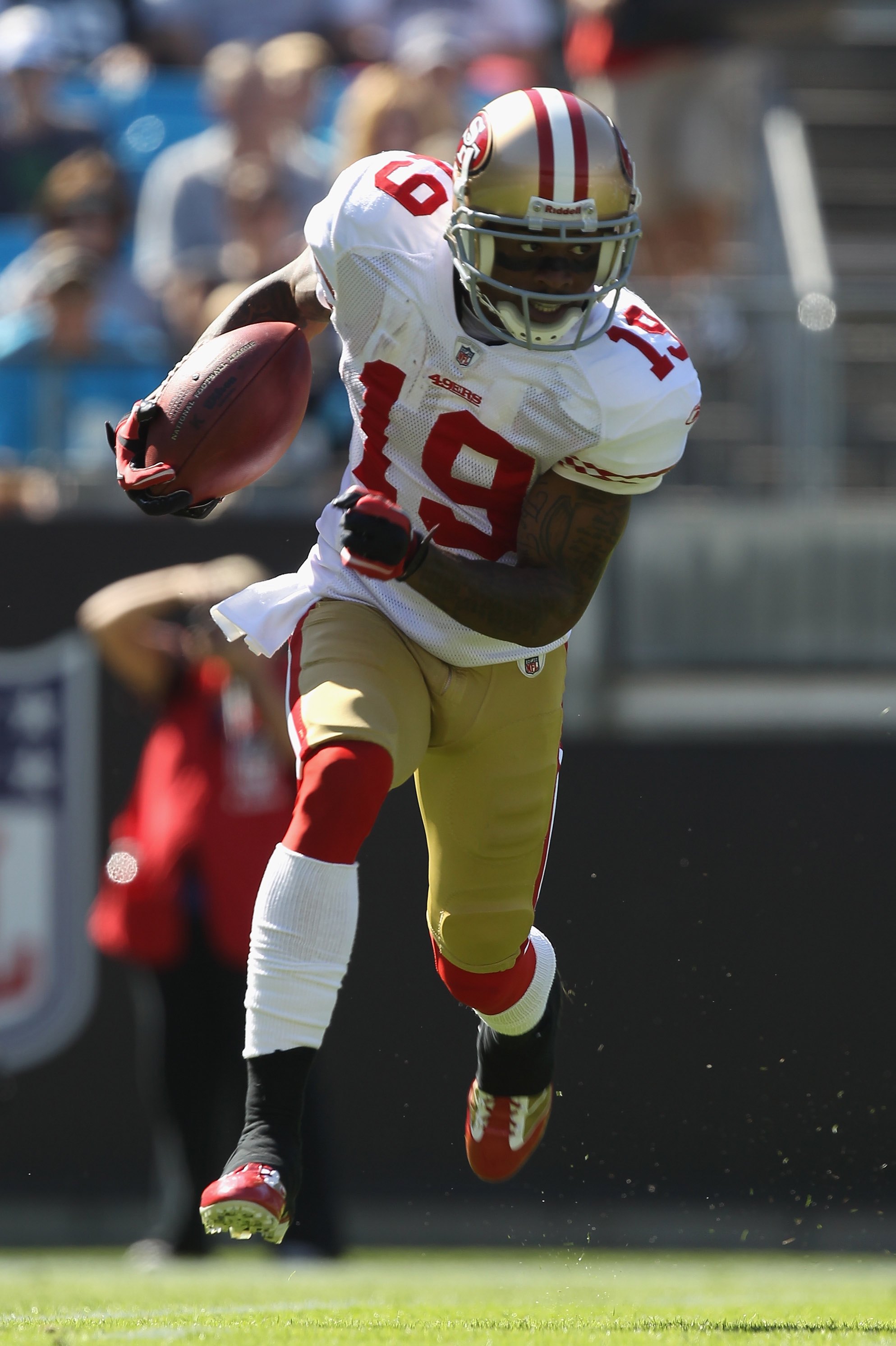 WR Ted Ginn, #19 49ers, runs with the ball during the NFL