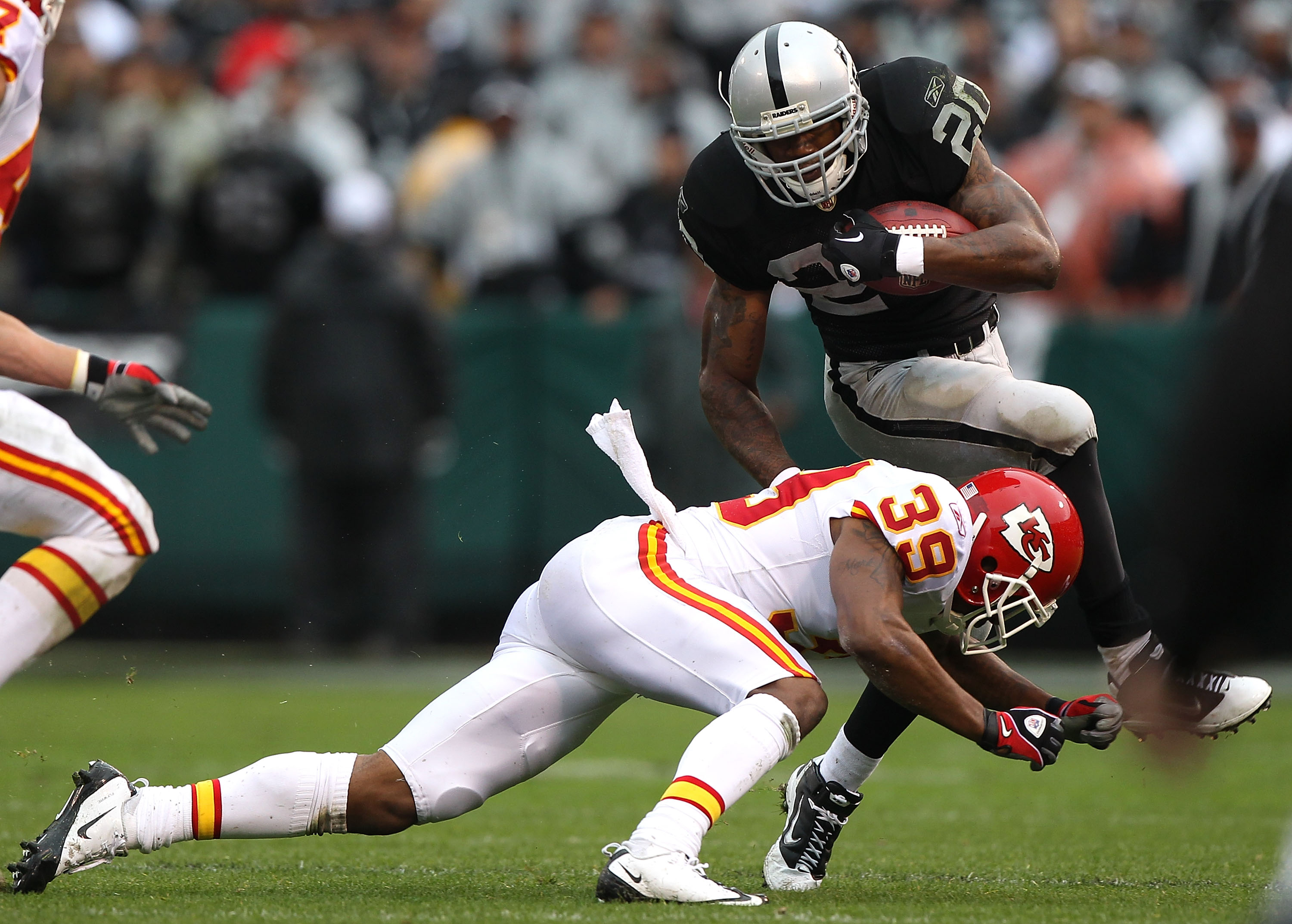 OAKLAND, CA - NOVEMBER 07:  Darren McFadden #20 of the Oakland Raiders is tackled by Brandon Carr #39 of the Kansas City Chiefs during an NFL game at Oakland-Alameda County Coliseum on November 7, 2010 in Oakland, California.  (Photo by Jed Jacobsohn/Gett