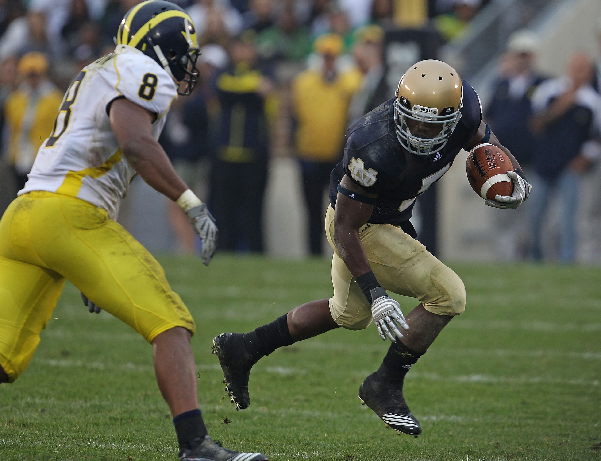 SOUTH BEND, IN - SEPTEMBER 11: Armando Allen, Jr. #5 of the Notre Dame Fighting Irish runs as Jonas Mouton #8 of the Michigan Wolverines closes in at Notre Dame Stadium on September 11, 2010 in South Bend, Indiana. Michigan defeated Notre Dame 28-24. (Pho SOUTH BEND, IN - SEPTEMBER 11: Armando Allen, Jr. #5 of the Notre Dame Fighting Irish runs as Jonas Mouton #8 of the Michigan Wolverines closes in at Notre Dame Stadium on September 11, 2010 in South Bend, Indiana. Michigan defeated Notre Dame 28-24. (Pho