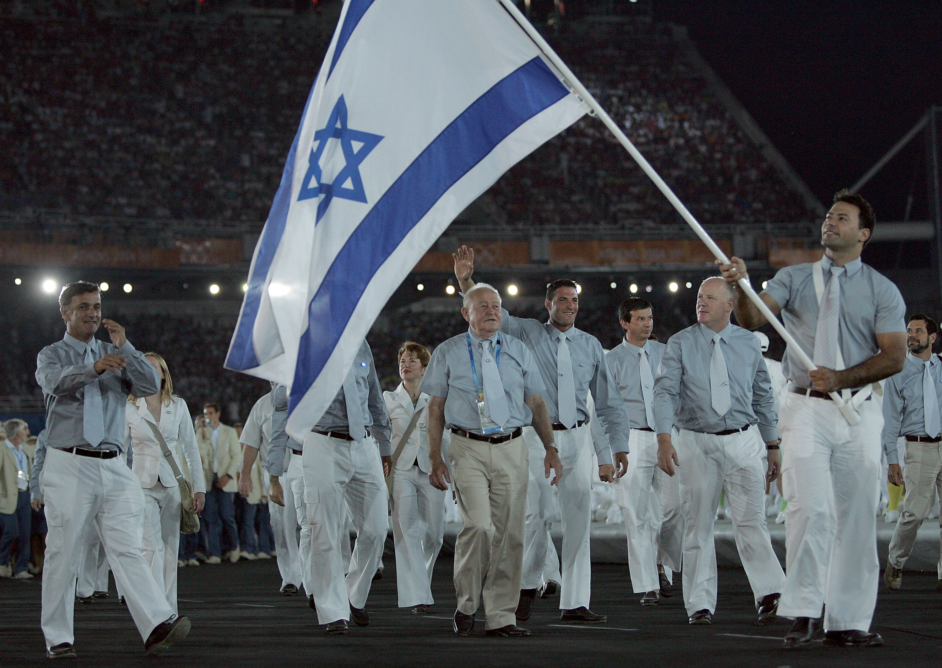 ATHENS - AUGUST 13:  Flag bearer Ariel Zeevie leads Team Israel during opening ceremonies for the Athens 2004 Summer Olympic Games on August 13, 2004 at the Sports Complex Olympic Stadium in Athens, Greece.  (Photo by Jamie Squire/Getty Images)