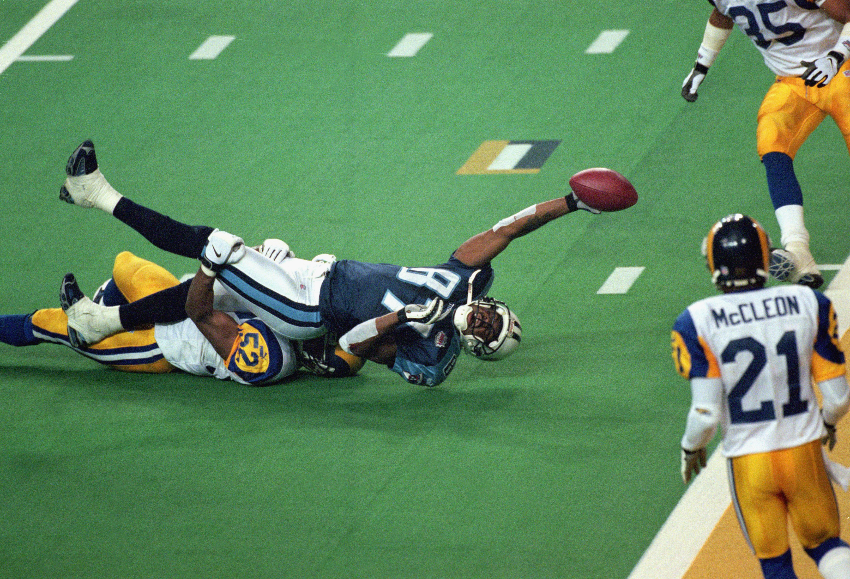 ATLANTA - JANUARY 30:  Kevin Dyson #87 of the Tennessee Titans reaches for the end zone with the ball as Mike Jones #52 of the St. Louis Rams tackles him on the last play of the game during the Super Bowl XXXIV Game at the Georgia Dome on January 30, 2000