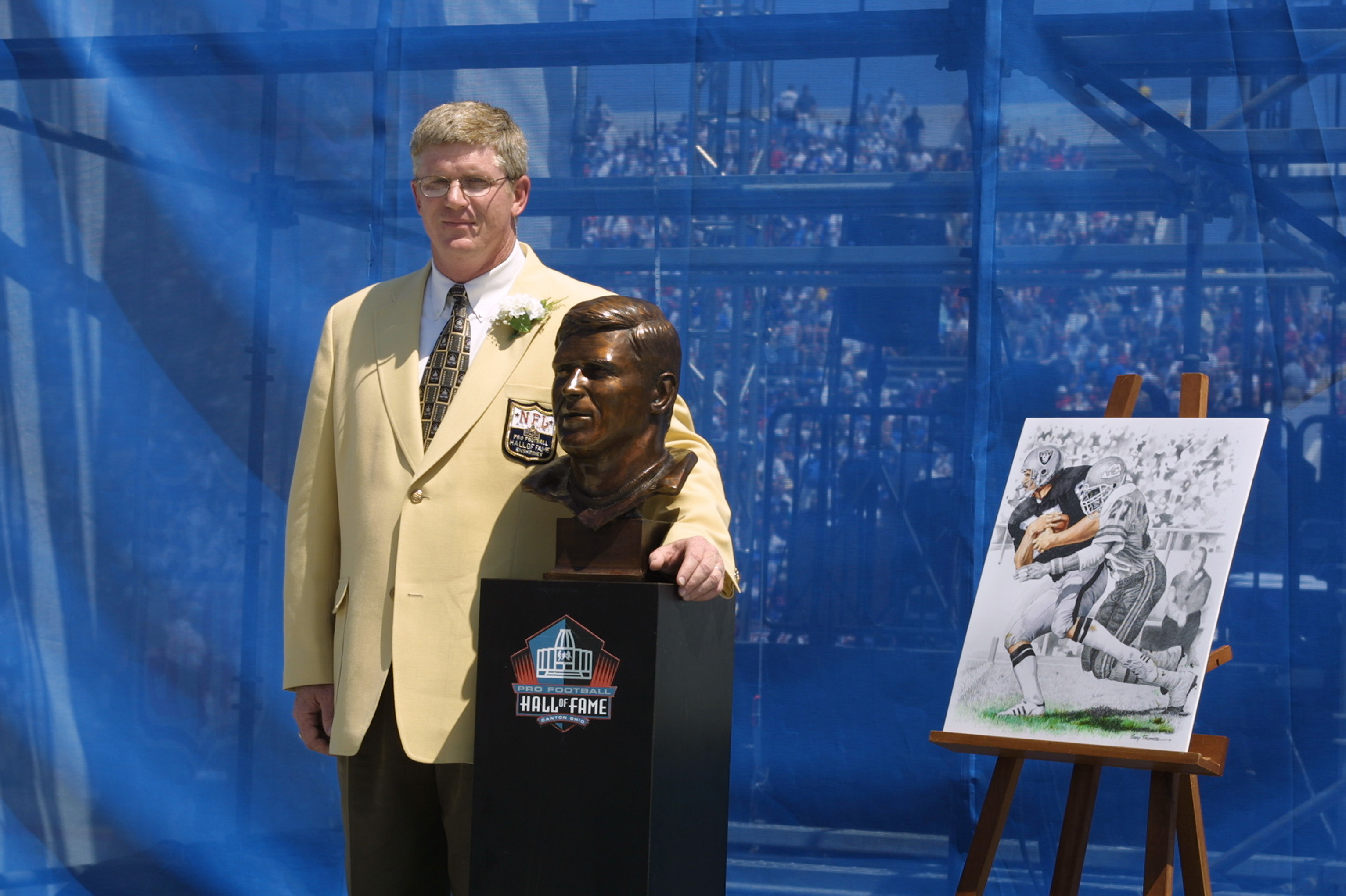 CANTON, OHIO - AUGUST 3:  Dave Casper stands next to his bust and artwork after his induction into the National Football League Hall of Fame on August 3, 2002 at Fawcett Stadium in Canton, Ohio.  Dave Casper played tight end from 1974 to 1984 for the Oakl