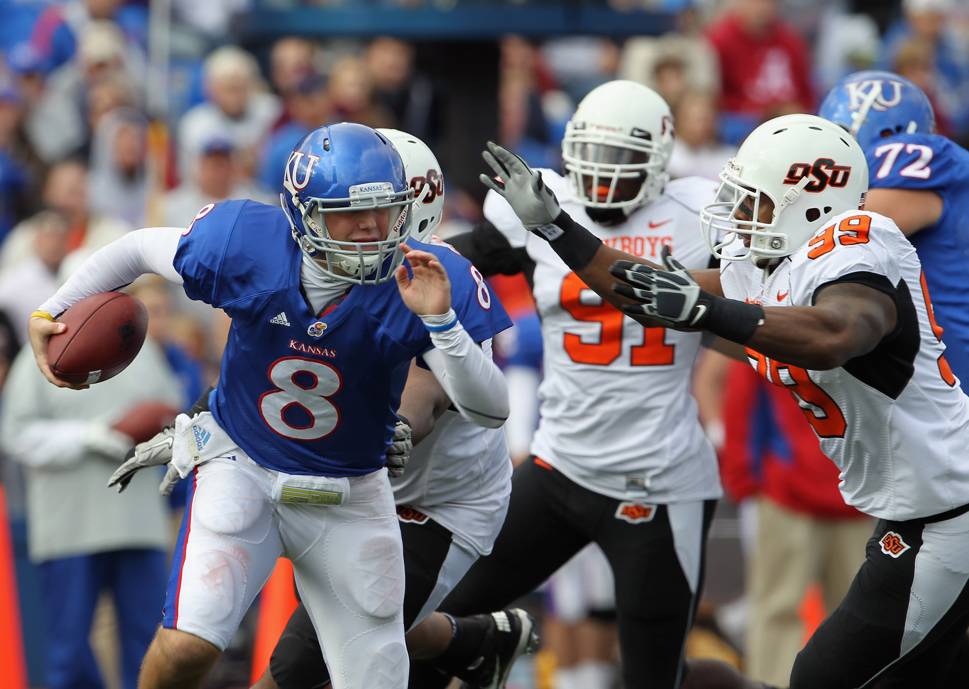 The OSU defense chases down Kansas quarterback Quinn Mecham