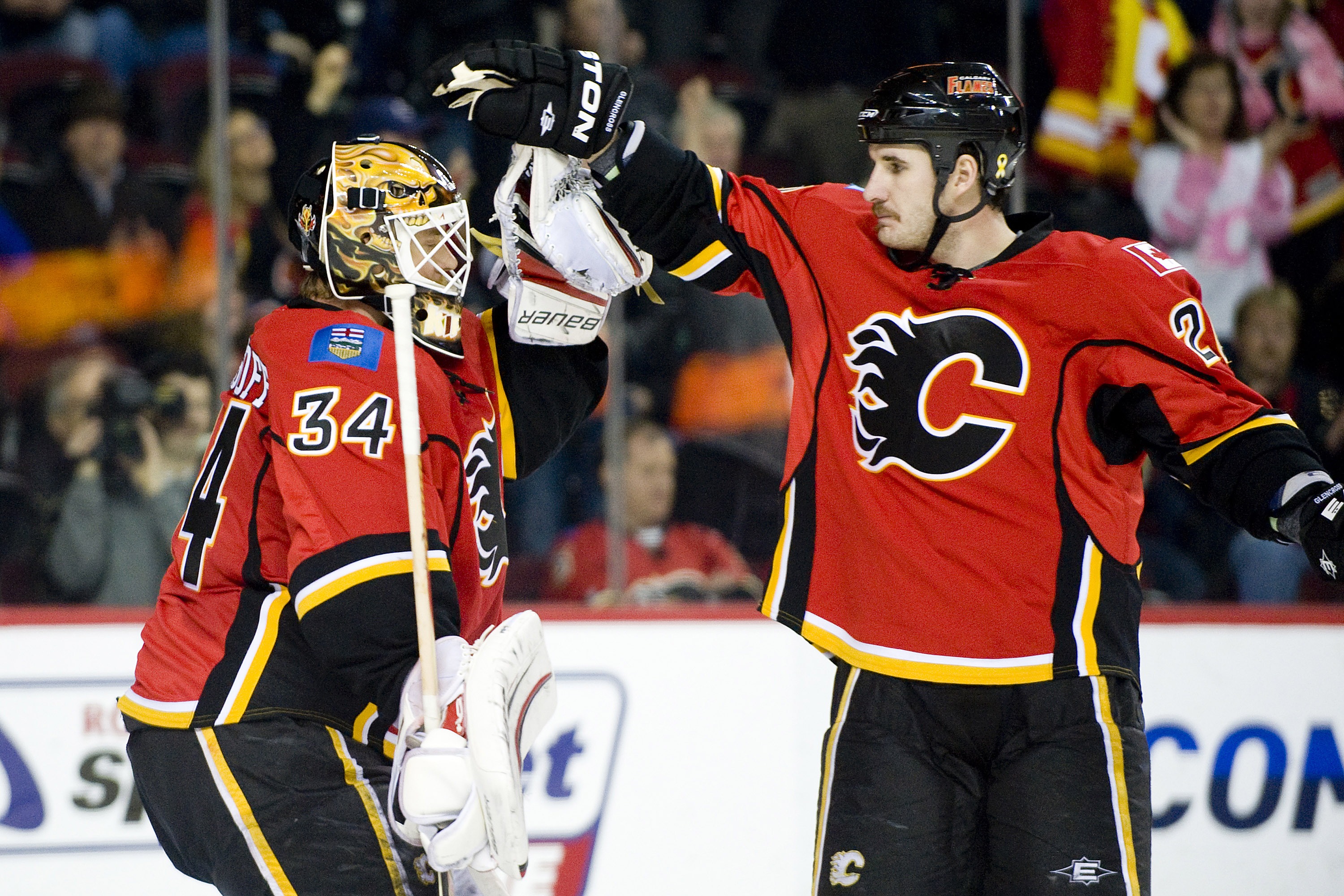 EDMONTON, AB - NOVEMBER 29:  Curtis Glencross #20 congratulates Miikka Kiprusoff #34 of the Calgary Flames after his shut-out performance against the Minnesota Wild at Scotiabank Saddledome on November 29, 2010 in Calgary, Alberta, Canada. The Flames beat