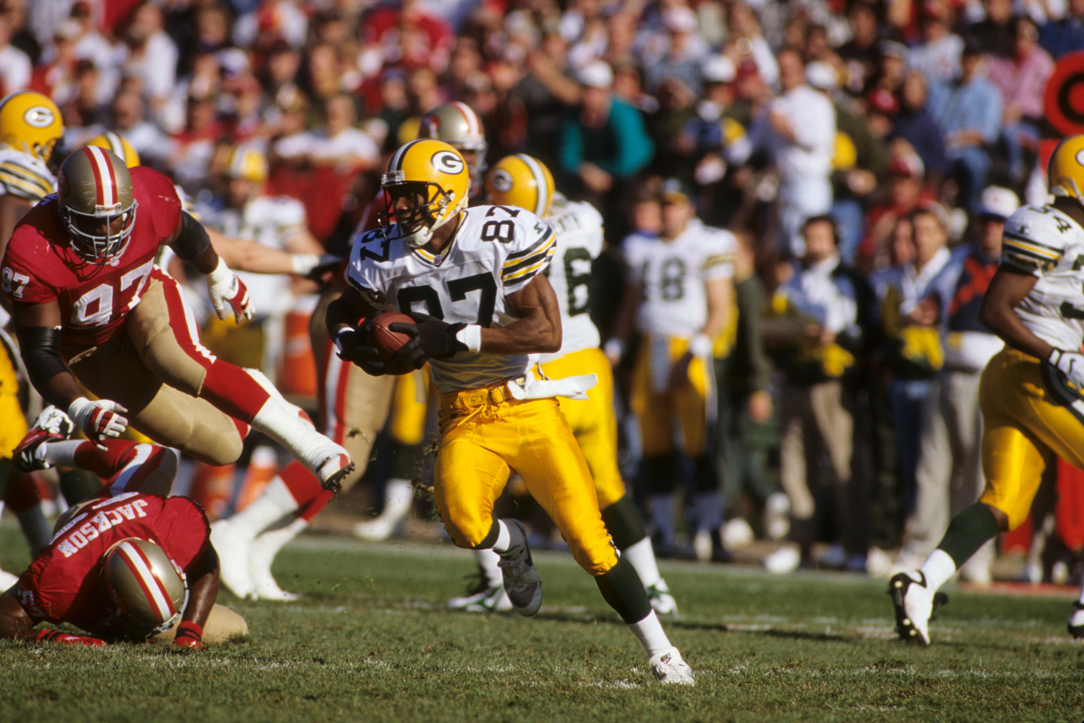 SAN FRANCISCO, CA - JANUARY 6:  Wide receiver Robert Brooks #87 of the Green Bay Packers runs with the ball during a NFC divisional playoff game against the San Francisco 49ers at Candlestick Park on January 6, 1996 in San Francisco, California.  The Pack