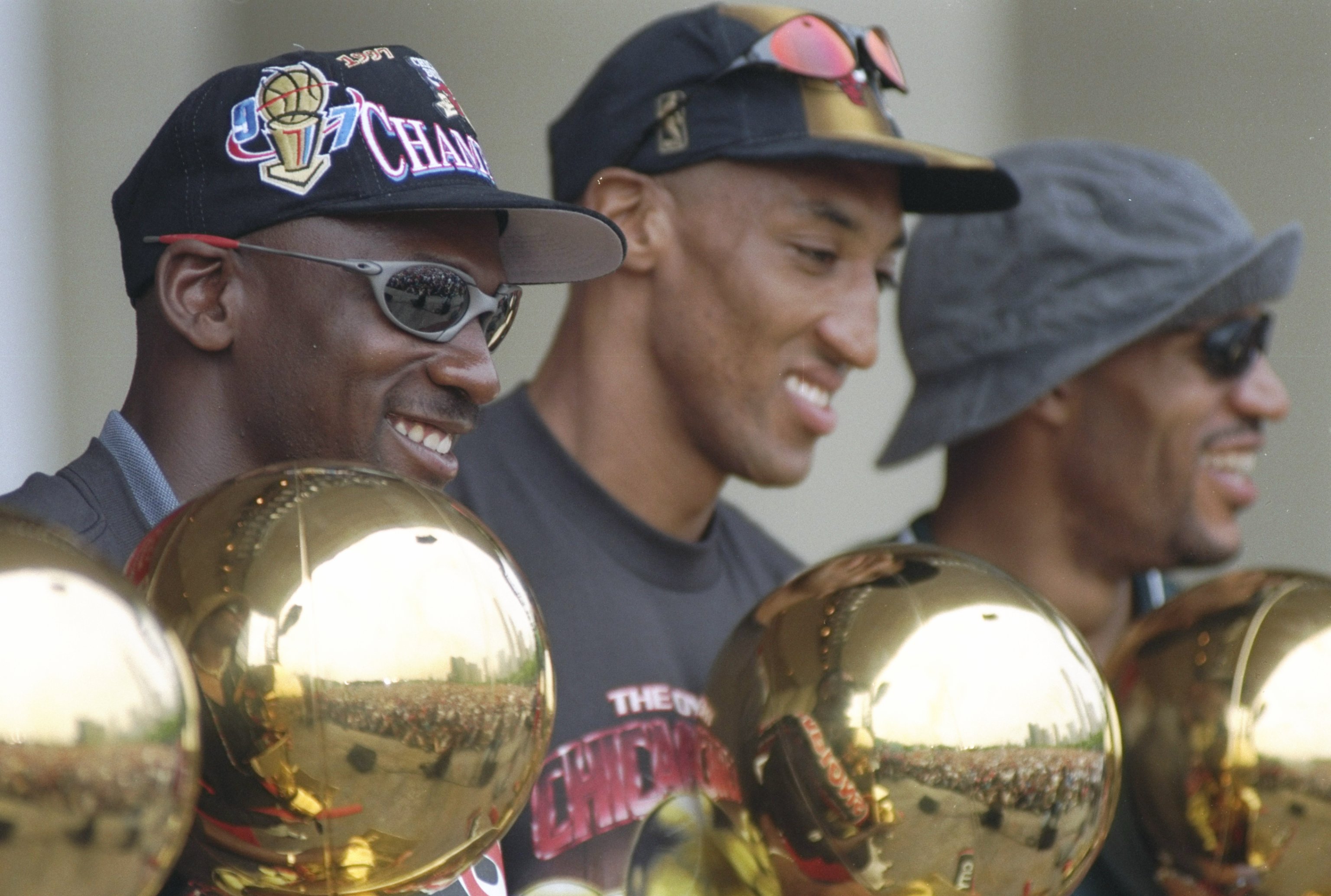 16 Jun 1997: Guard Michael Jordan, forward Scottie Pippen and forward Dennis Rodman of the Chicago Bulls look at their trophies during the Chicago Bulls Victory Parade in Chicago, Illinois. The BUlls defeated the Utah Jazz in 6 games to win the 1998 NBA C