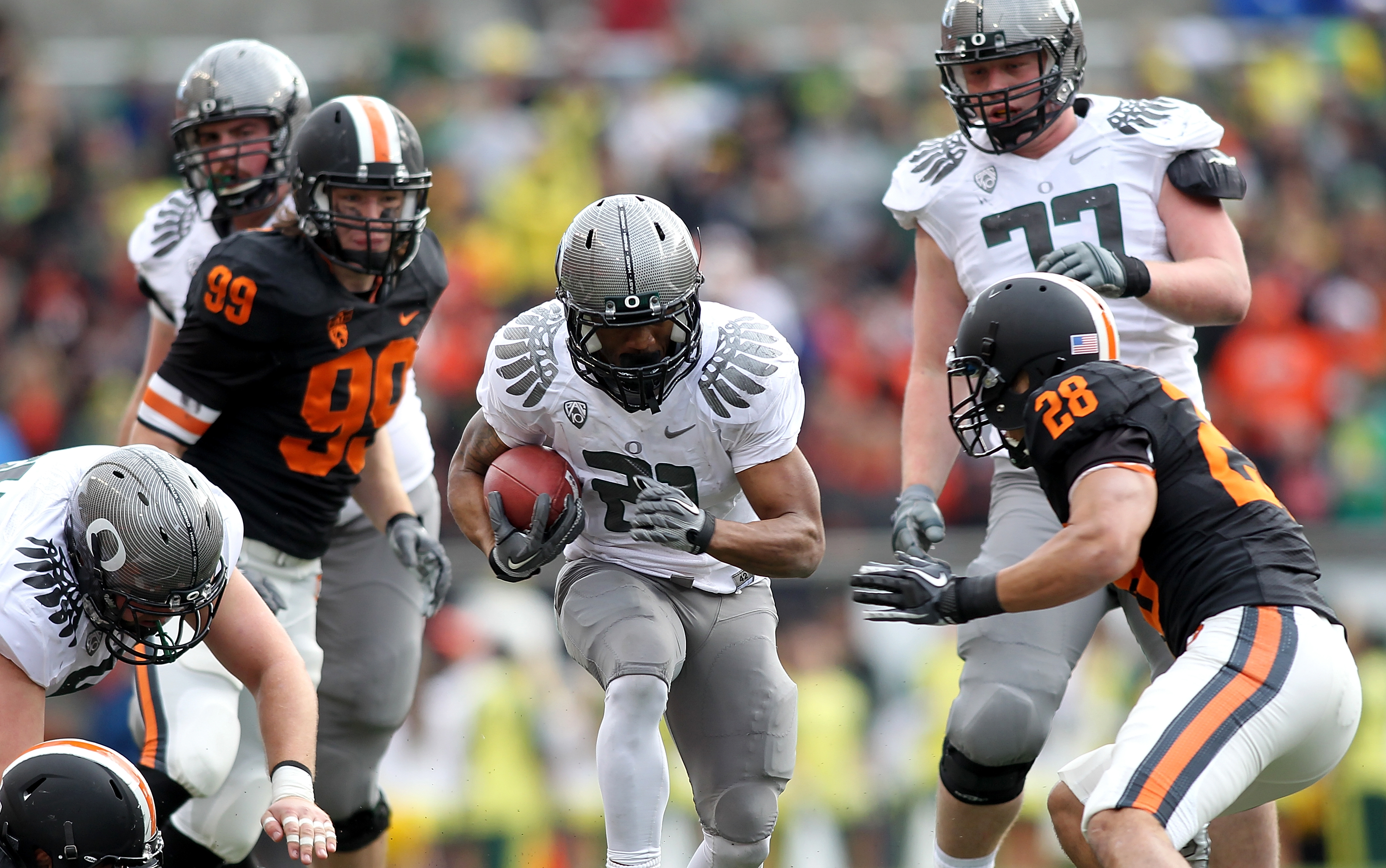 CORVALLIS, OR - DECEMBER 04:  LaMichael James #21 of the Oregon Ducks runs the ball against  Suaesi Tuimanei #28 of the Oregon State Beavers during the 114th Civil War on December 4, 2010 at the Reser Stadium in Corvallis, Oregon.  (Photo by Jonathan Ferr