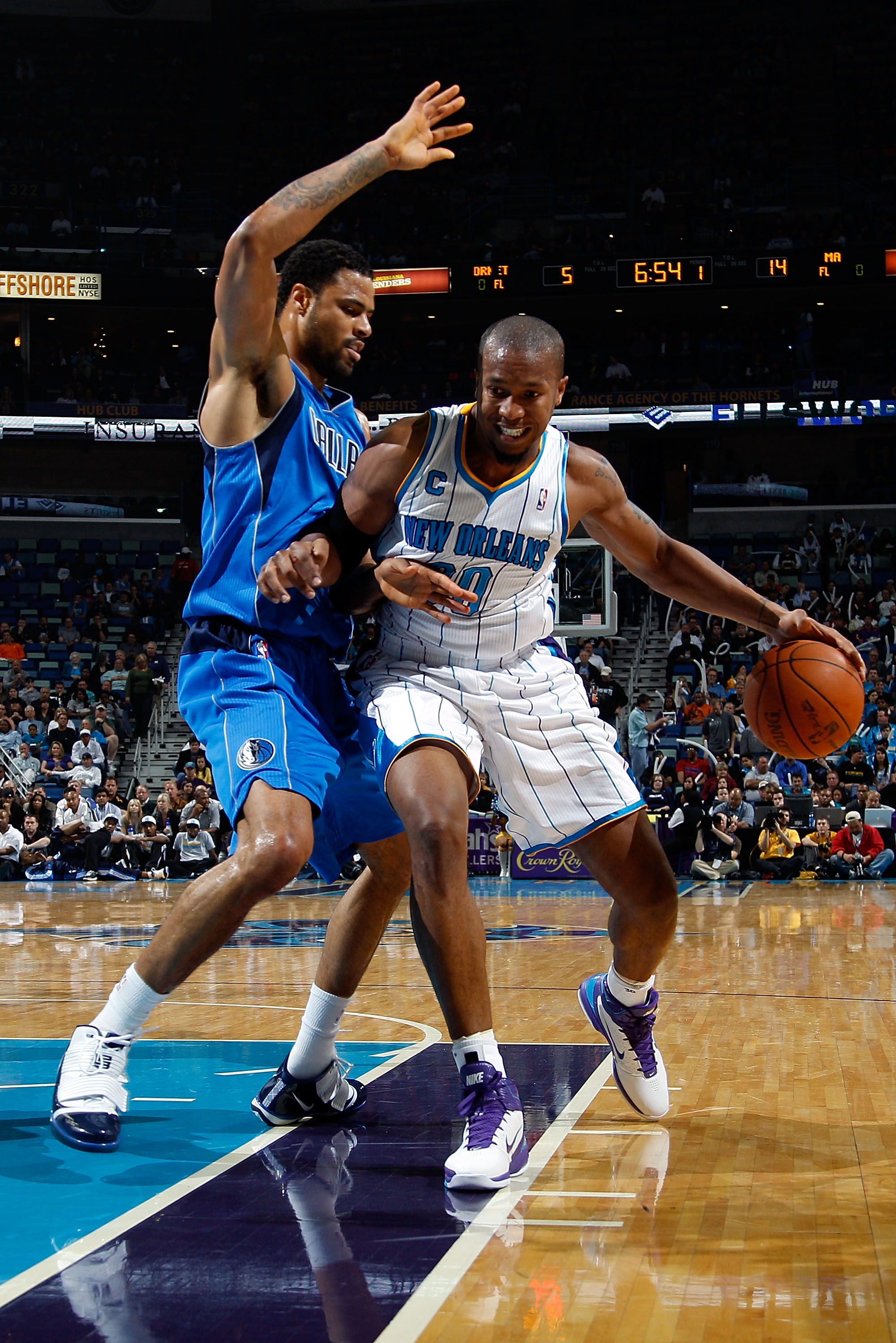 NEW ORLEANS - NOVEMBER 17:  David West #30 of the New Orleans Hornets drives the ball around Tyson Chandler #6 of the Dallas Mavericks at the New Orleans Arena on November 17, 2010 in New Orleans, Louisiana.  The Hornets defeated the Mavericks 99-97.  NOT