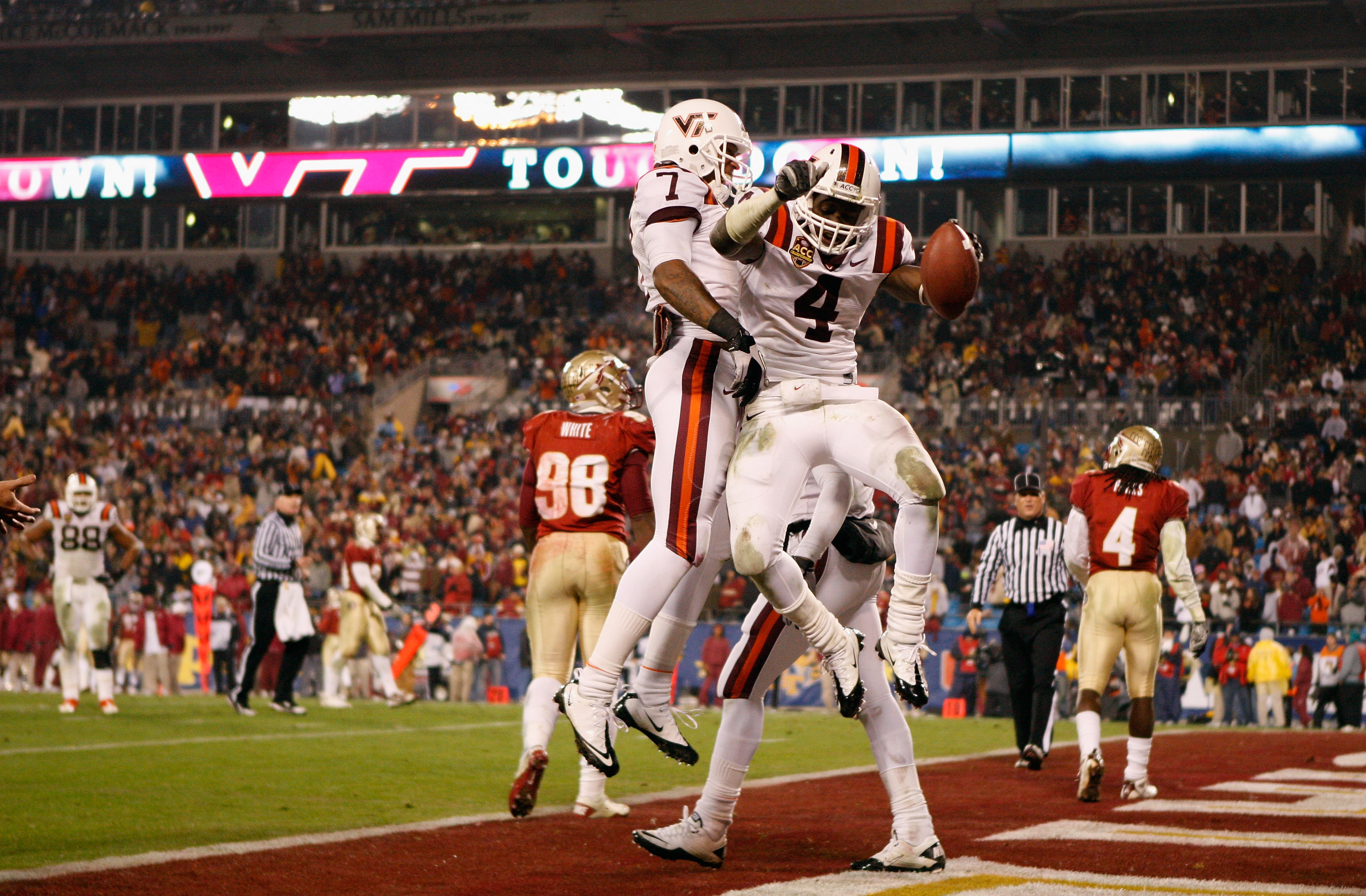 CHARLOTTE, NC - DECEMBER 04:  David Wilson #4 of the Virginia Tech Hokies celebrates after scoring a touchdown with teammate Marcus Davis during their game against the Florida State Seminoles at Bank of America Stadium on December 4, 2010 in Charlotte, No