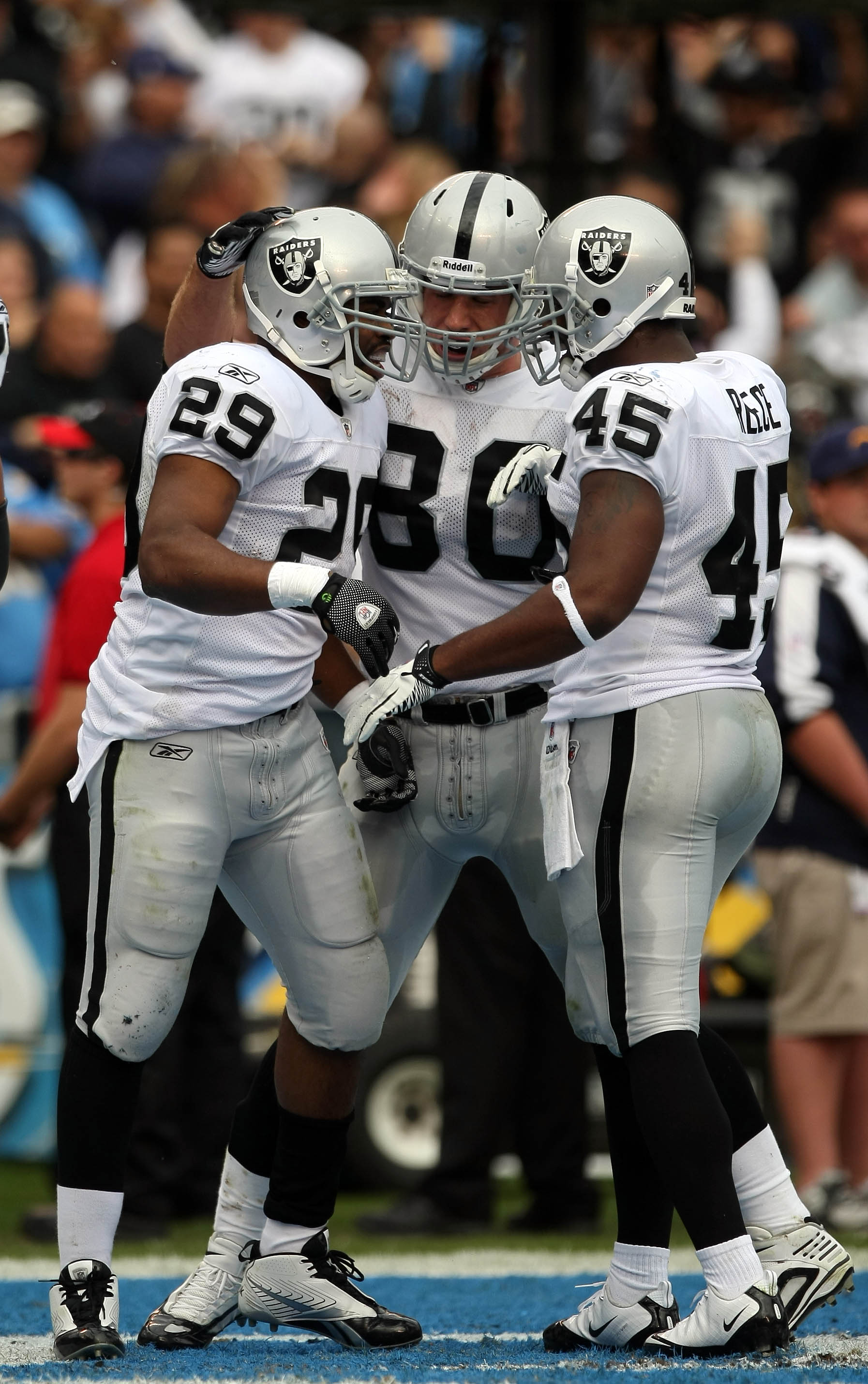 SAN DIEGO, CA - DECEMBER 5: Runningback Michael Bush #29 of the Oakland Raiders is congratulated by teammates Zach Miller #80 and Marcel Reece #45 after scoring a touchdown during their NFL game at Qualcomm Stadium on December 5, 2010 in San Diego, Califo