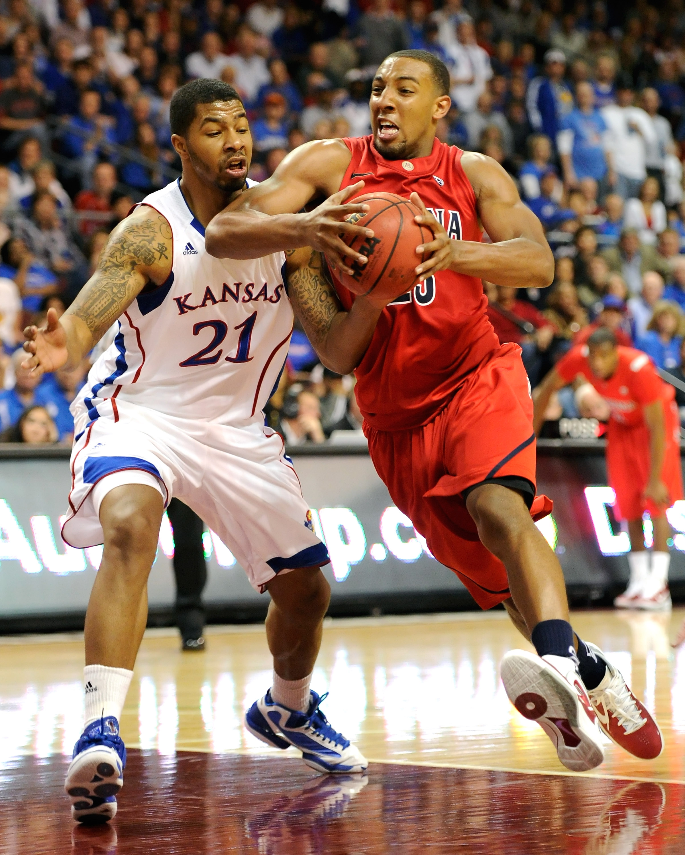 LAS VEGAS - NOVEMBER 27: Markieff Morris #21 of the Kansas Jayhawks fouls Derrick Williams #23 of the Arizona Wildcats during the championship game of the Las Vegas Invitational at The Orleans Arena November 27, 2010 in Las Vegas, Nevada. Kansas won 87-7