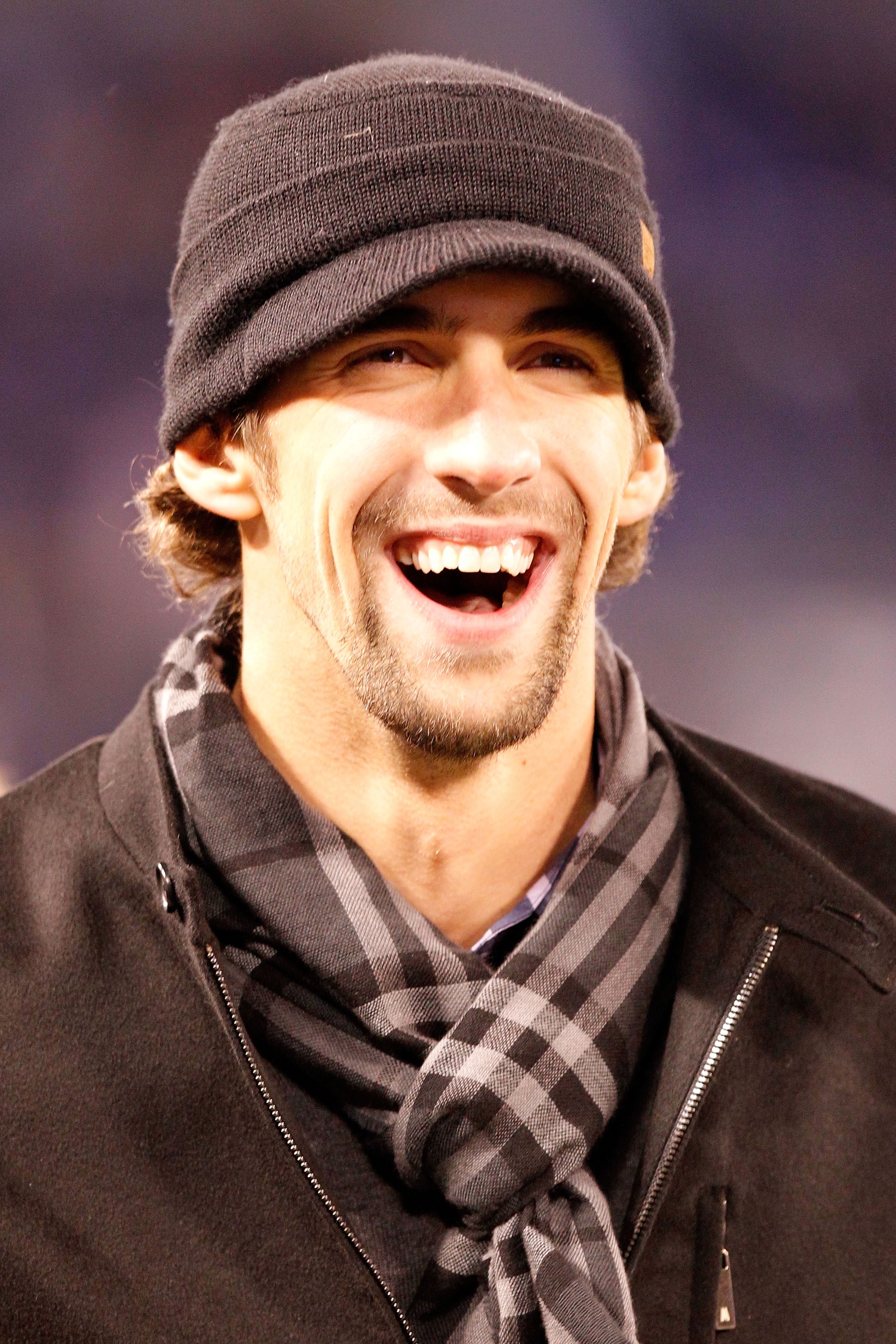 BALTIMORE, MD - DECEMBER 05:  American swimmer Michael Phelps smiles as he watches the Baltimore Ravens and the Pittsburgh Steelers during the first quarter of the game at M&T Bank Stadium on December 5, 2010 in Baltimore, Maryland.  (Photo by Geoff Burke
