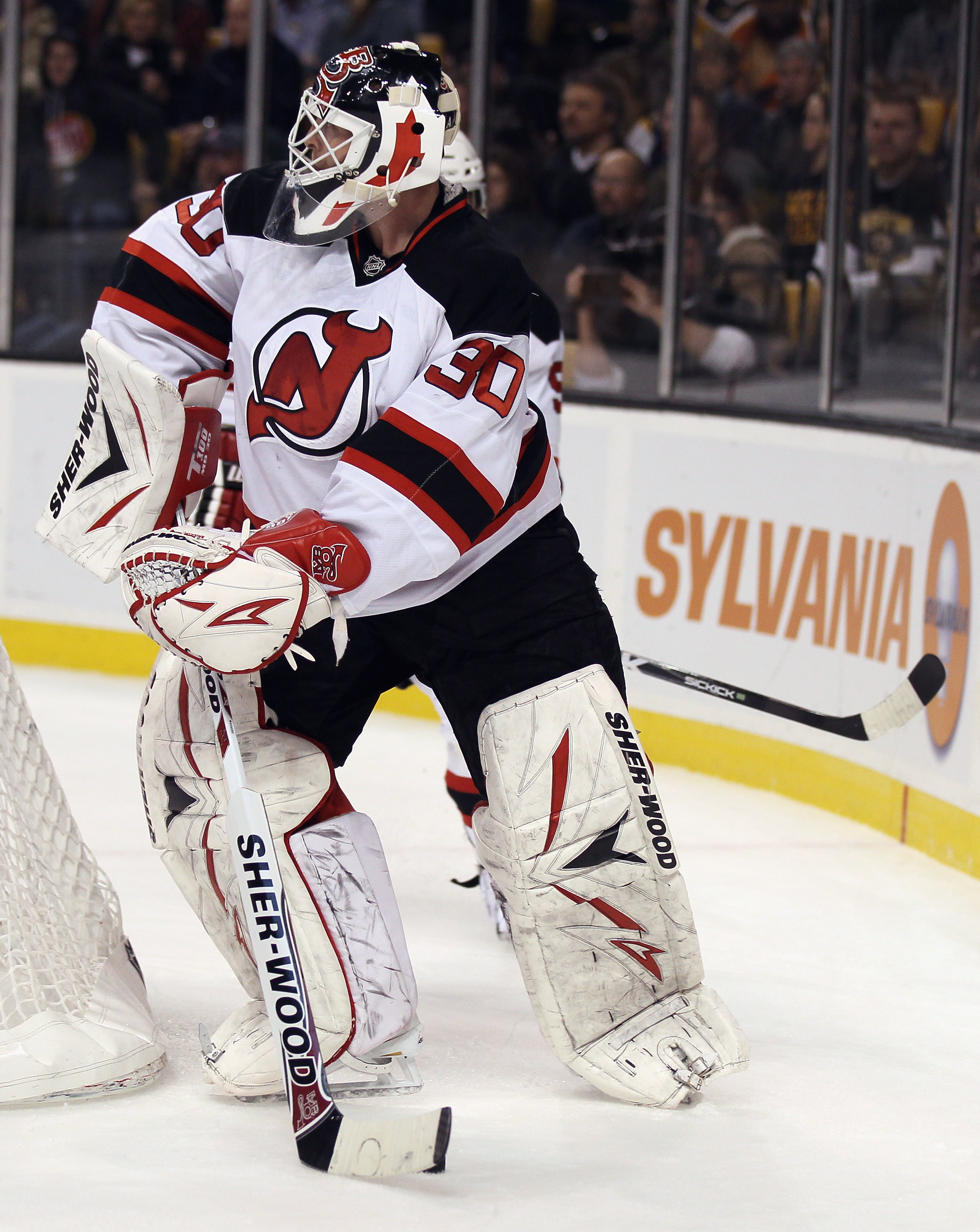 BOSTON - NOVEMBER 15:  Martin Brodeur #30 of the New Jersey Devils clears the puck in the first period against the Boston Bruins on November 15, 2010 at the TD Garden in Boston, Massachusetts.  (Photo by Elsa/Getty Images)