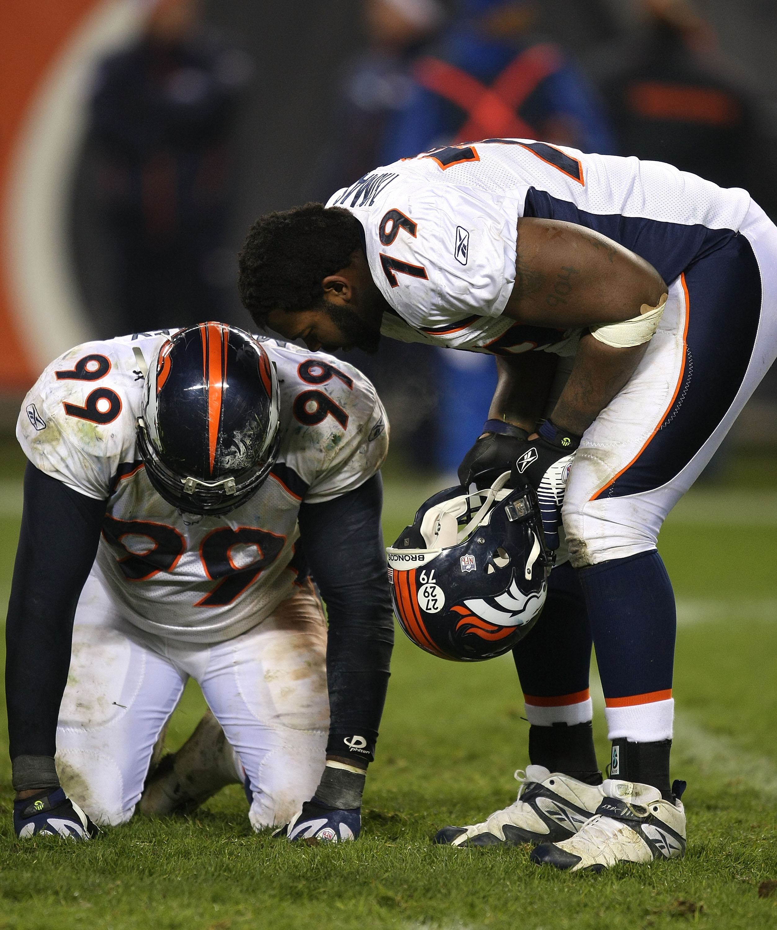 CHICAGO - NOVEMBER 25: Alvin McKinley #99 and Marcus Thomas #79 of the Denver Broncos react after losing to the Chicago Bears on a field goal in overtime on November 25, 2007 at Soldier Field in Chicago, Illinois. (Photo by Jonathan Daniel/Getty Images)