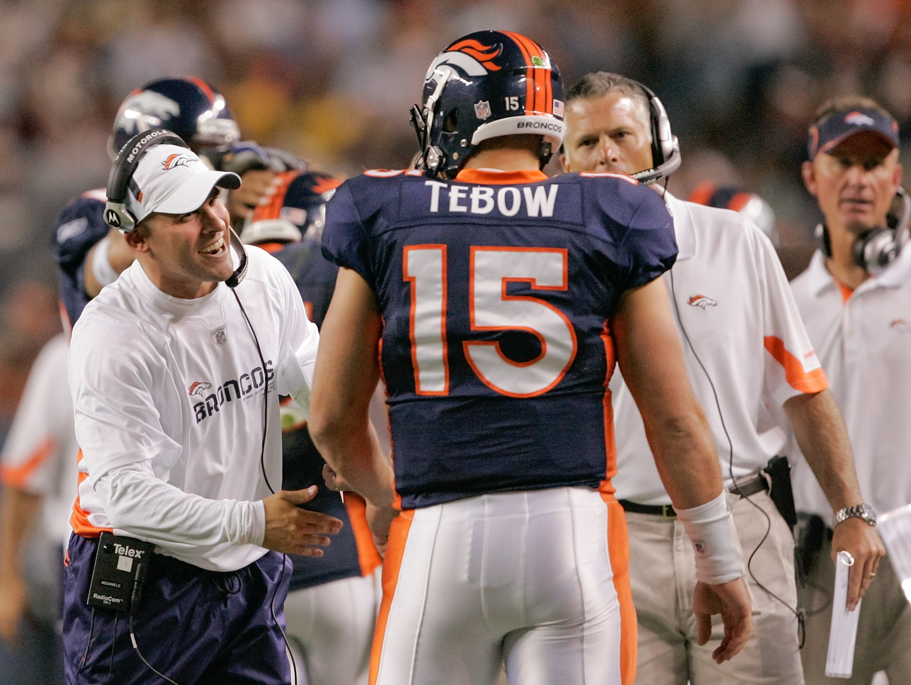 DENVER - AUGUST 29: Head coach Josh McDaniels of the Denver Broncos congratulates quarterback Tim Tebow #15 following his fourth quarter touchdown pass against the Pittsburgh Steelers at INVESCO Field at Mile High on August 29, 2010 in Denver, Colorado.