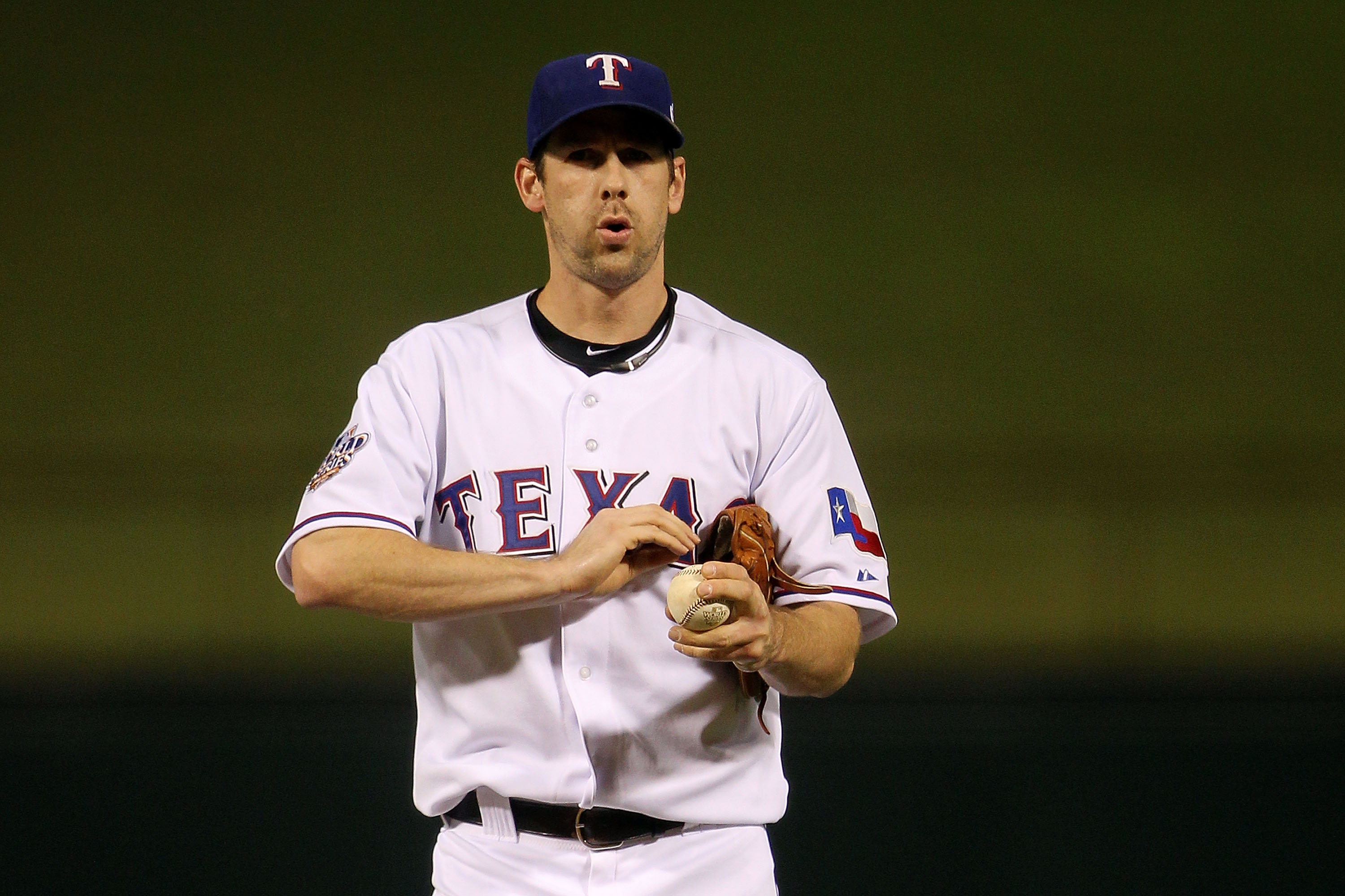 ARLINGTON, TX - NOVEMBER 01:  Cliff Lee #33 of the Texas Rangers pitches gets set to throw a pitch against the San Francisco Giants in Game Five of the 2010 MLB World Series at Rangers Ballpark in Arlington on November 1, 2010 in Arlington, Texas.  (Photo
