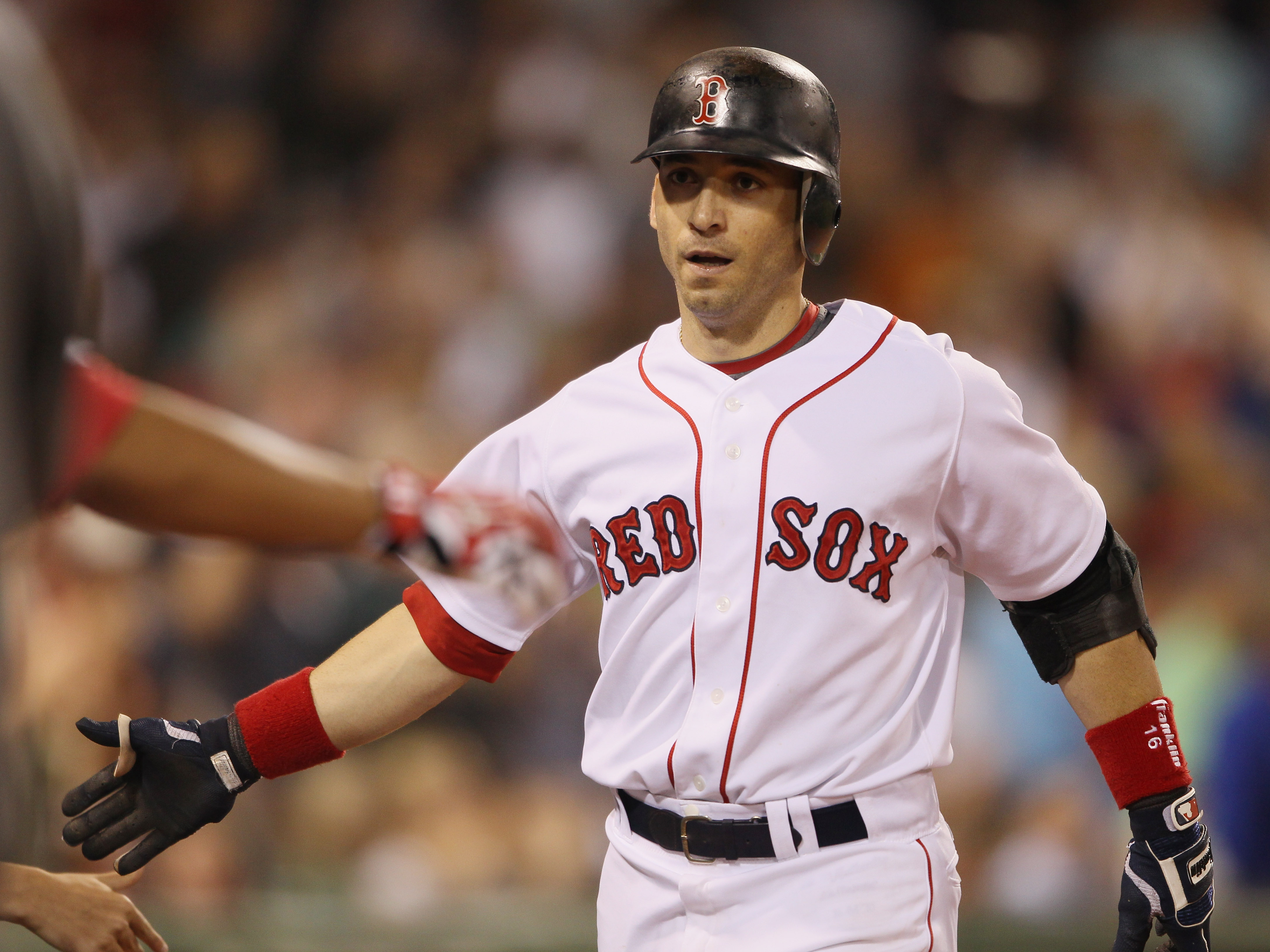 BOSTON - SEPTEMBER 08:  Marco Scutaro #16 of the Boston Red Sox is congratulated after he hit a two run homer against the Tampa Bay Rays on September 8, 2010 at Fenway Park in Boston, Massachusetts.  (Photo by Elsa/Getty Images)