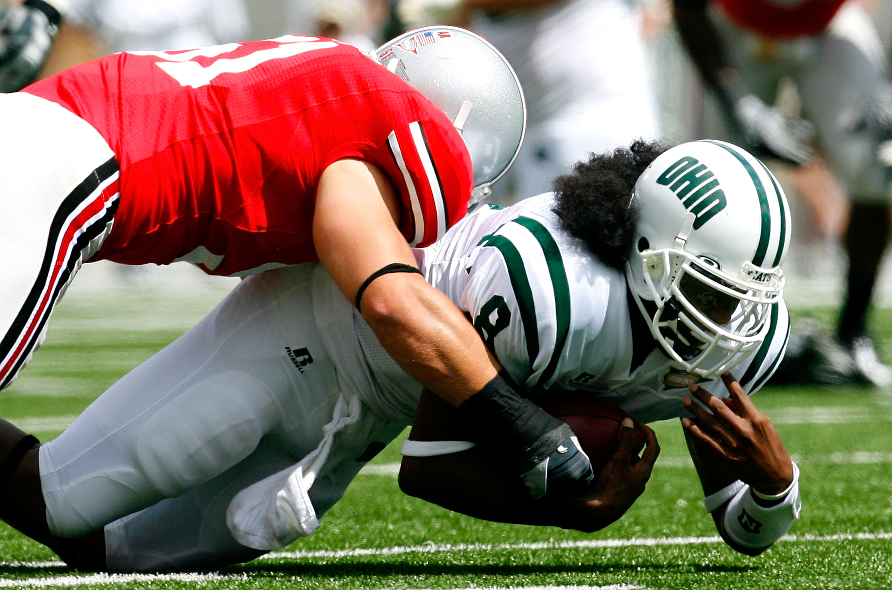 COLUMBUS, OH - SEPTEMBER 06: Quarterback Boo Jackson #8 of the Ohio Bobcats dives for more yardage against linebacker Ross Homan #51 of the Ohio State Buckeyes during the game at Ohio Stadium on September 6, 2008 in Columbus, Ohio. (Photo by Kevin C. Co