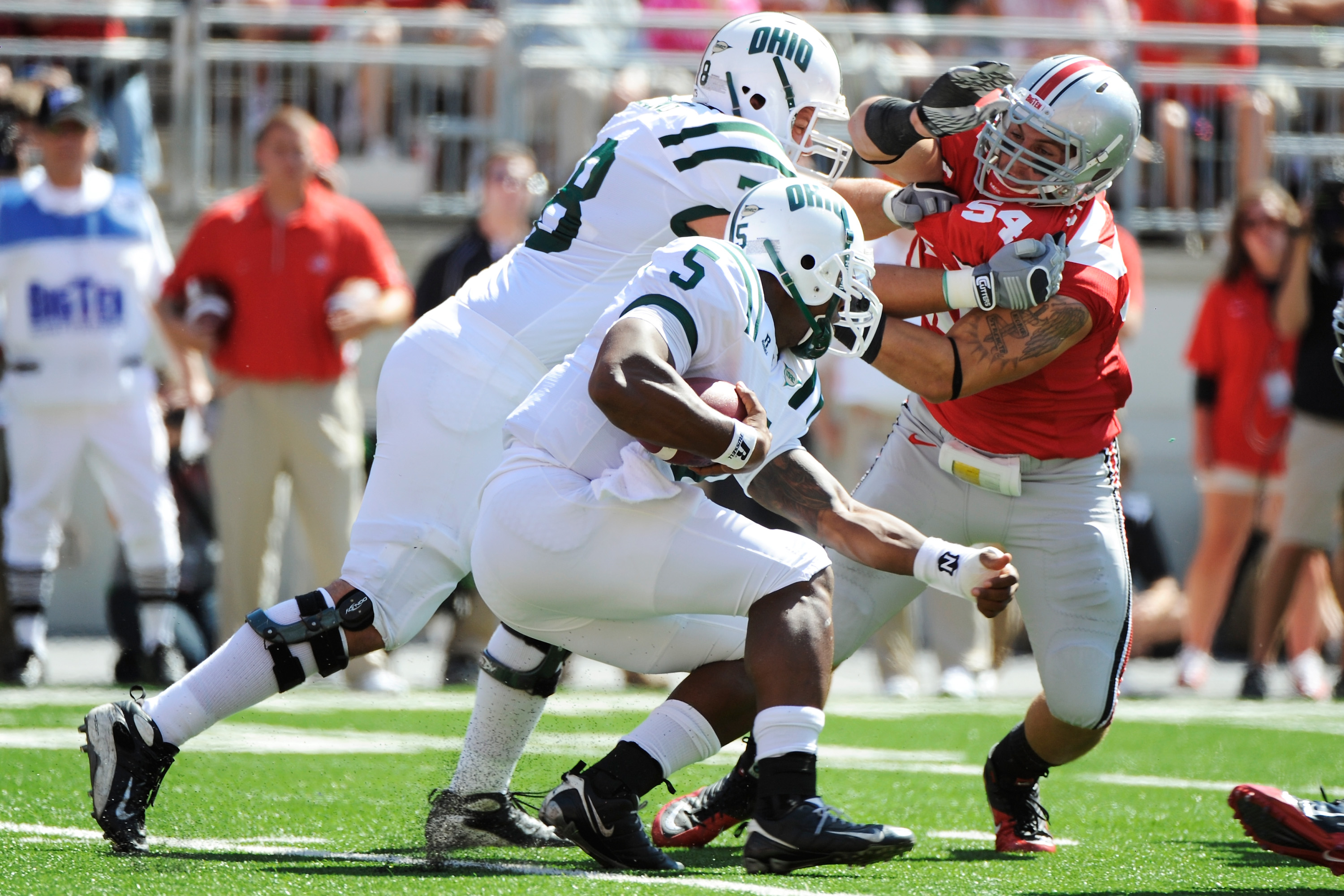COLUMBUS, OH - SEPTEMBER 18: John Simon #54 of the Ohio State Buckeyes fights off a block to get to ballcarrier Phil Bates #5 of the Ohio Bobcats at Ohio Stadium on September 18, 2010 in Columbus, Ohio. (Photo by Jamie Sabau/Getty Images)