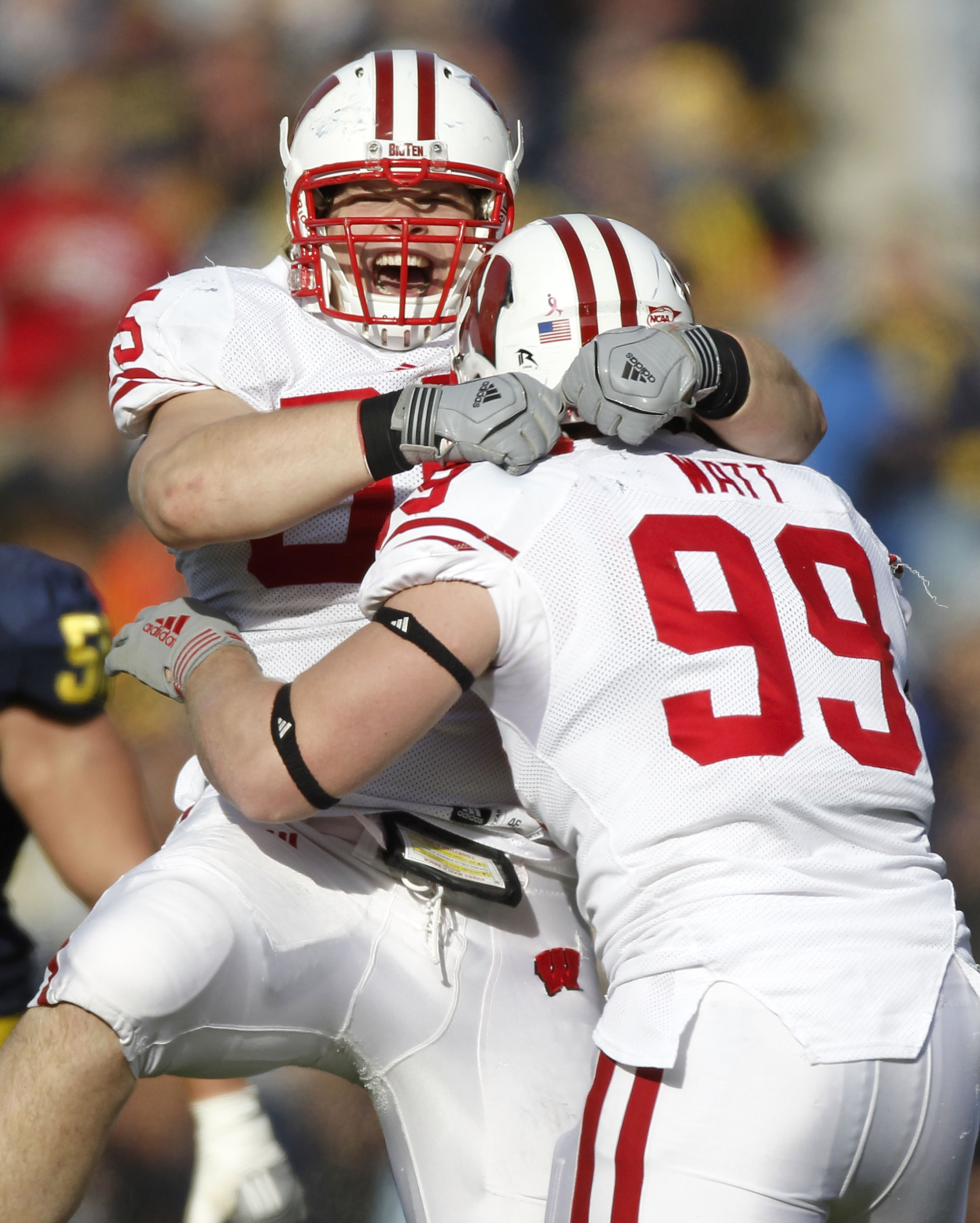 ANN ARBOR, MI - NOVEMBER 20: J.J. Watt #99 of the Wisconsin Badgers celebrates a fourth quarter interception with Patrick Butrym #95 while playing the Michigan Wolverines at Michigan Stadium on November 20, 2010 in Ann Arbor, Michigan. Wisconson won the
