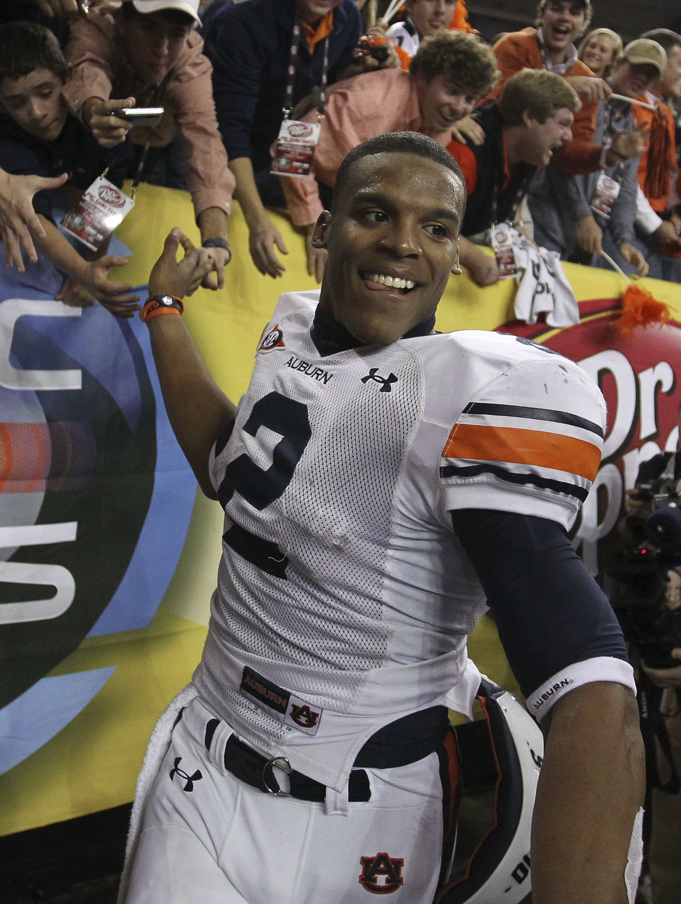 ATLANTA - DECEMBER 04: Quarterback Cam Newton #2 of the Auburn Tigers celebrates with the crowd after the 2010 SEC Championship against the South Carolina Gamecocks at Georgia Dome on December 4, 2010 in Atlanta, Georgia. The Tigers beat the Gamecocks 5
