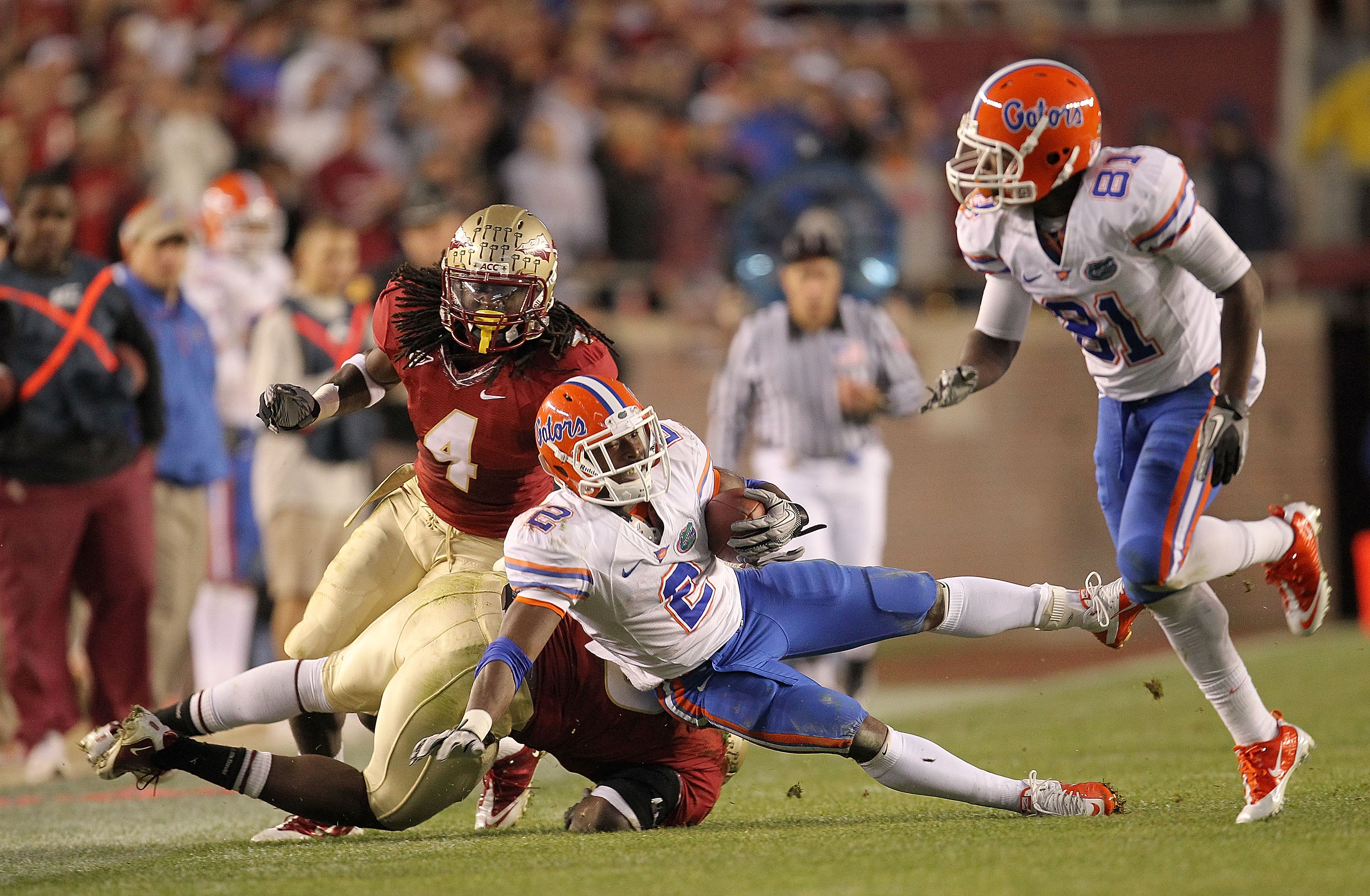 TALLAHASSEE, FL - NOVEMBER 27:  Jeff Demps #2 of the Florida Gators is tackled by Terrance Parks #4 of the Florida State Seminoles  during a game at Doak Campbell Stadium on November 27, 2010 in Tallahassee, Florida.  (Photo by Mike Ehrmann/Getty Images)