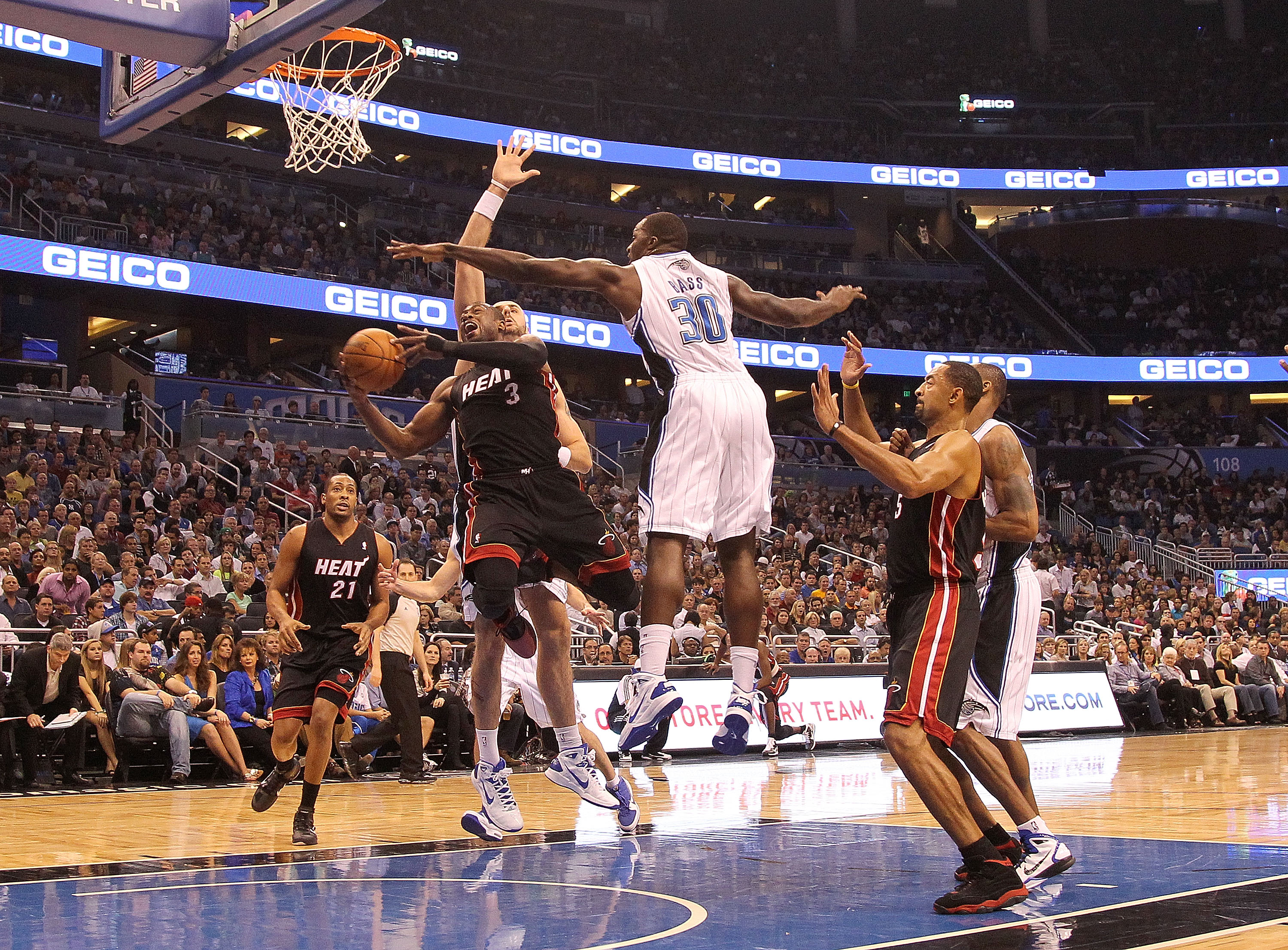ORLANDO, FL - NOVEMBER 24:  Dwyane Wade #3 of the Miami Heat shoots over Brandon Bass #30 of the Orlando Magic during a game at Amway Arena on November 24, 2010 in Orlando, Florida. NOTE TO USER: User expressly acknowledges and agrees that, by downloading