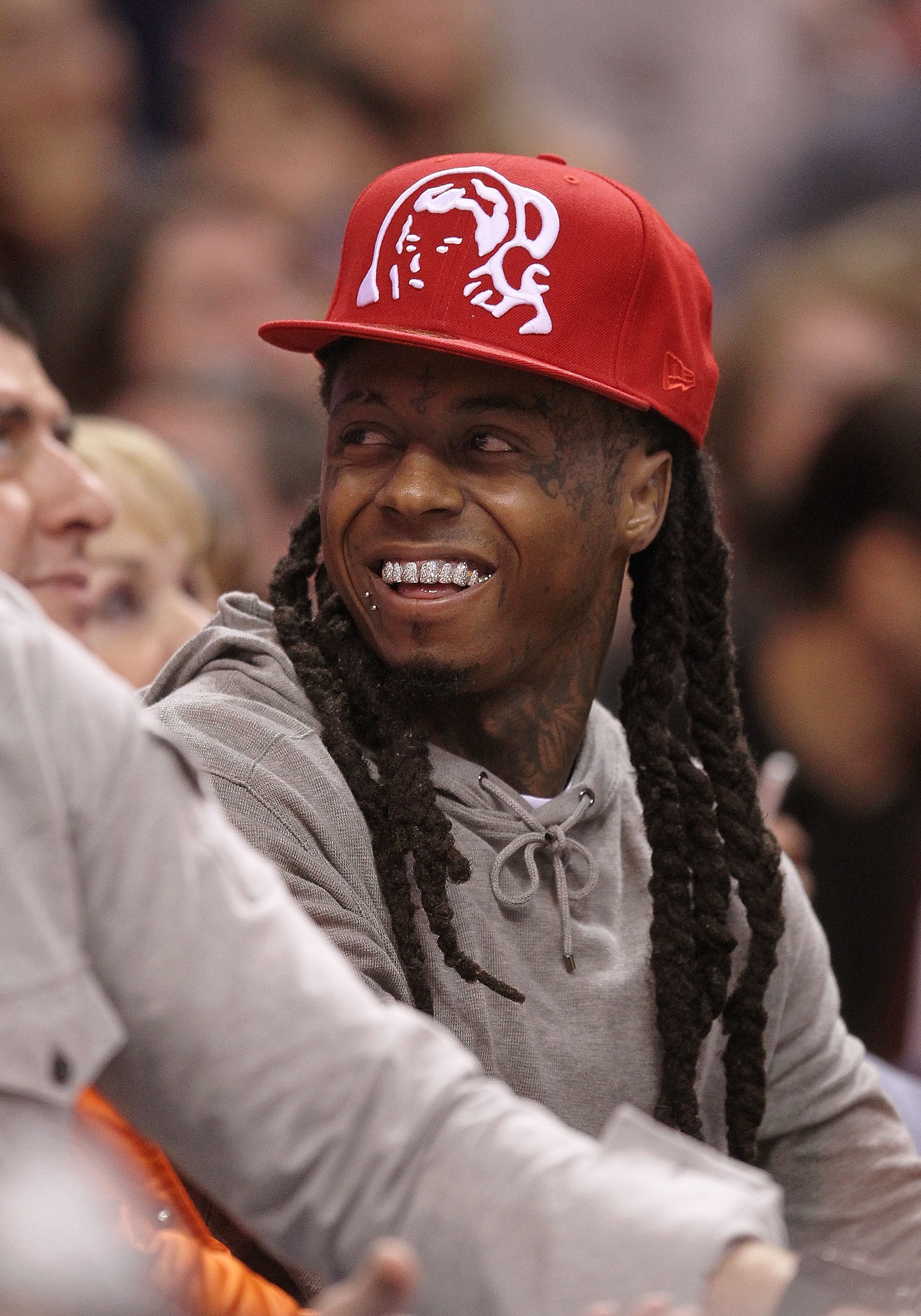 MIAMI - NOVEMBER 19: Rapper Lil' Wayne watches a game between the Miami Heat and the Charlotte Bobcats at American Airlines Arena on November 19, 2010 in Miami, Florida. NOTE TO USER: User expressly acknowledges and agrees that, by downloading and/or usin