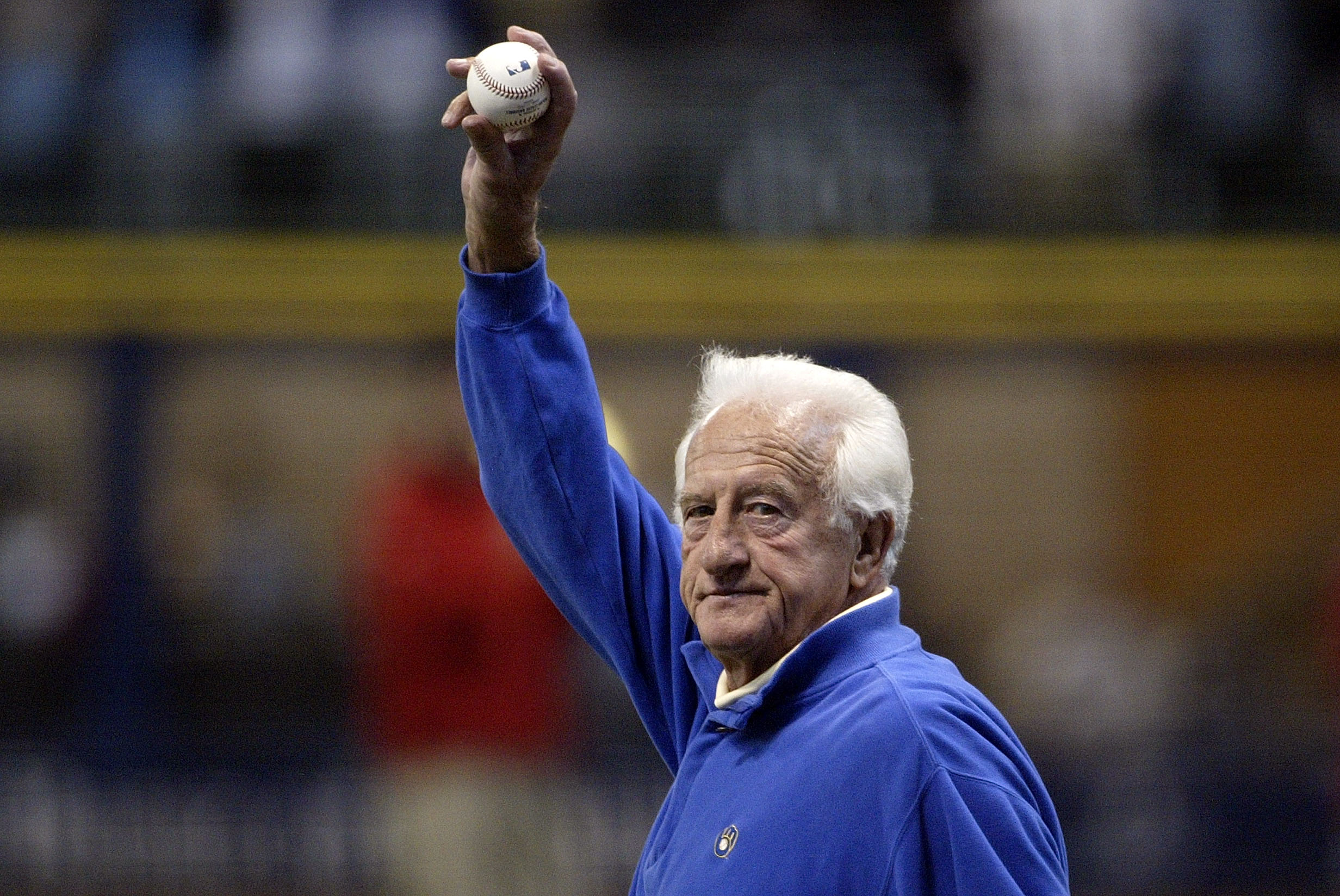 MILWAUKEE - OCTOBER 04:  Former major league baseball player Bob Uecker waves to the fans as he walks out to mound to throw out the ceremonial first pitch prior to the Milwaukee Brewers playing against the Philadelphia Phillies in Game three of the NLDS d