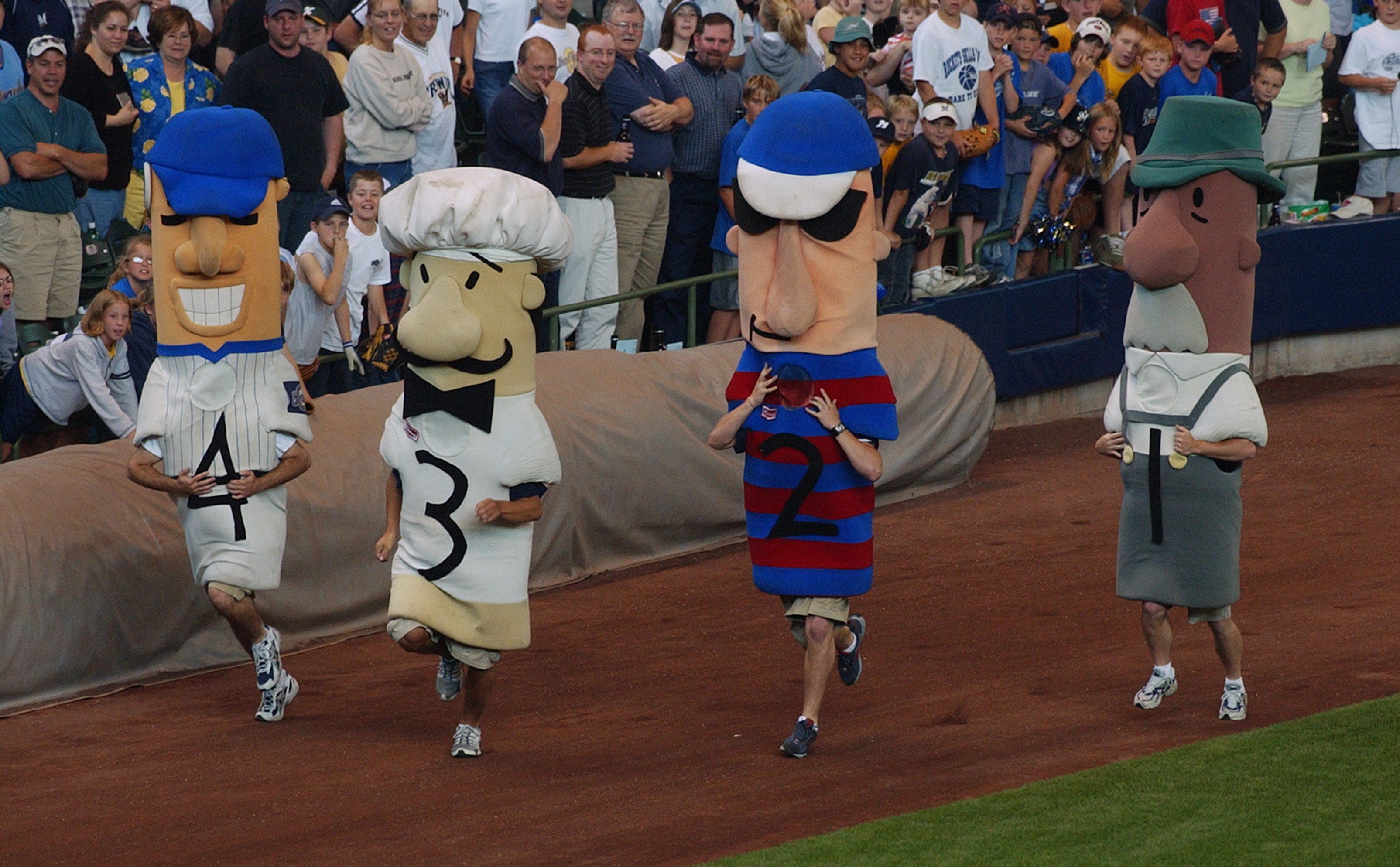 MILWAUKEE - JUNE 17:  A view of the Polish sausage, the Italian sausage, the Hot Dog, and the Bratwurst in the famous Sausage Race taken during the game between the Milwaukee Brewers and the Seattle Mariners on June 17, 2004 at Miller Park in Milwaukee, W