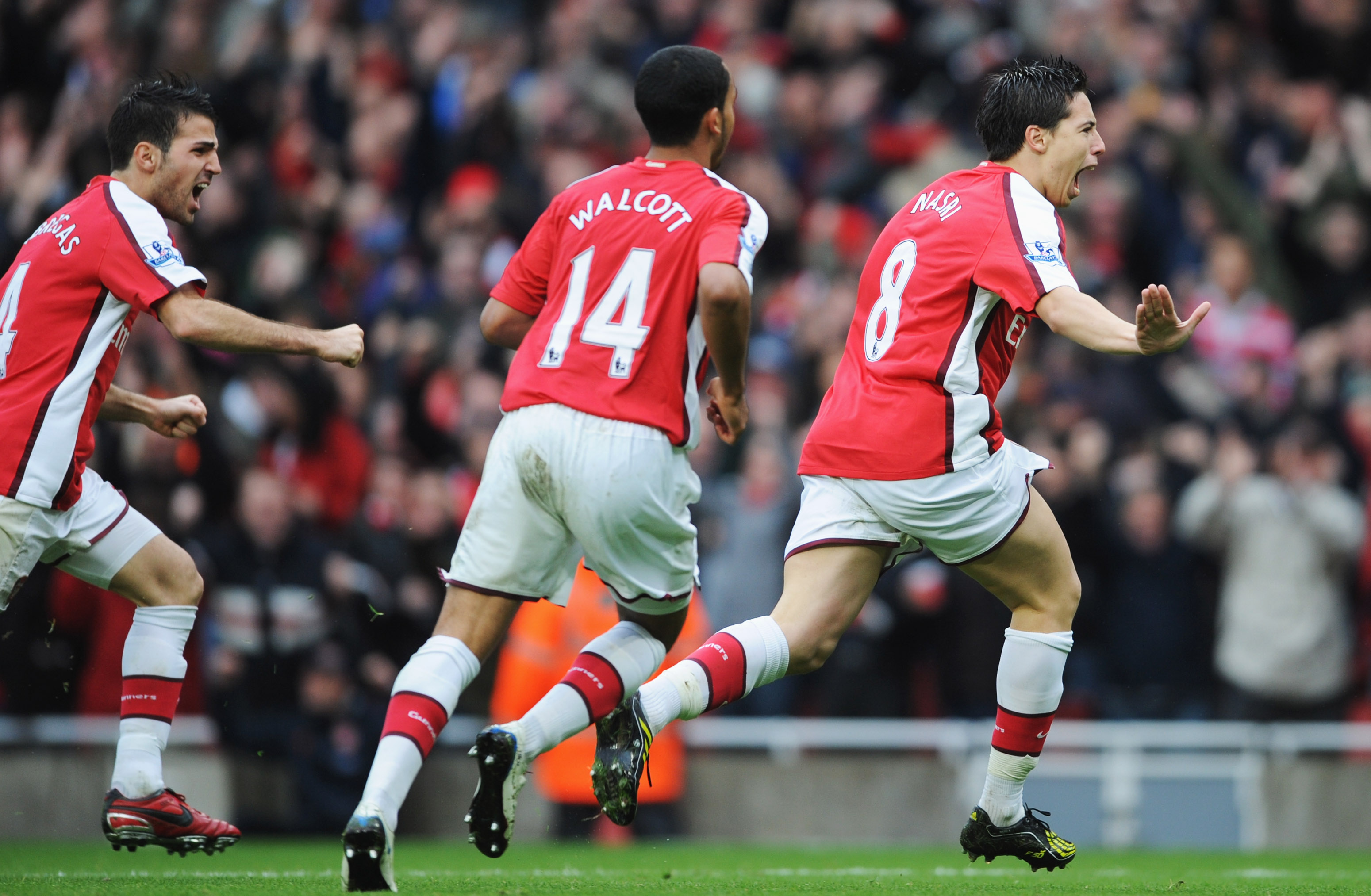 LONDON - NOVEMBER 08:  Samir Nasri of Arsenal (R) celebrates with Theo Walcott and Francesc Fabregas as he scores their second goal during the Barclays Premier League match between Arsenal and Manchester United at the Emirates Stadium on November 8, 2008