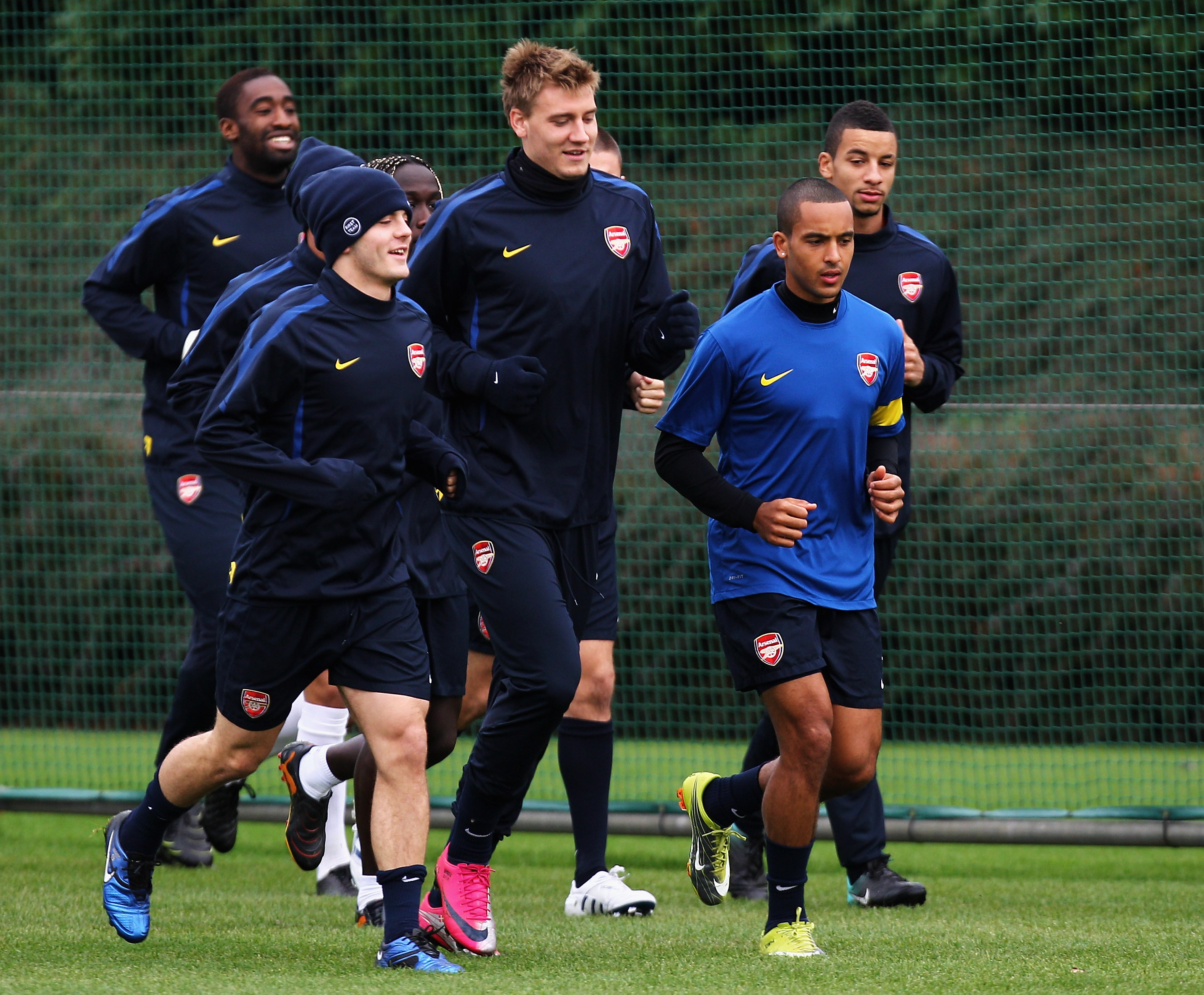 ST ALBANS, ENGLAND - NOVEMBER 02:  (L-R) Jack Wilshere, Nicklas Bendtner and Theo Walcott lead the warm up during a training session ahead of the UEFA Champions League Group H match against Shakhtar Donetsk at the club's complex at London Colney on Novemb