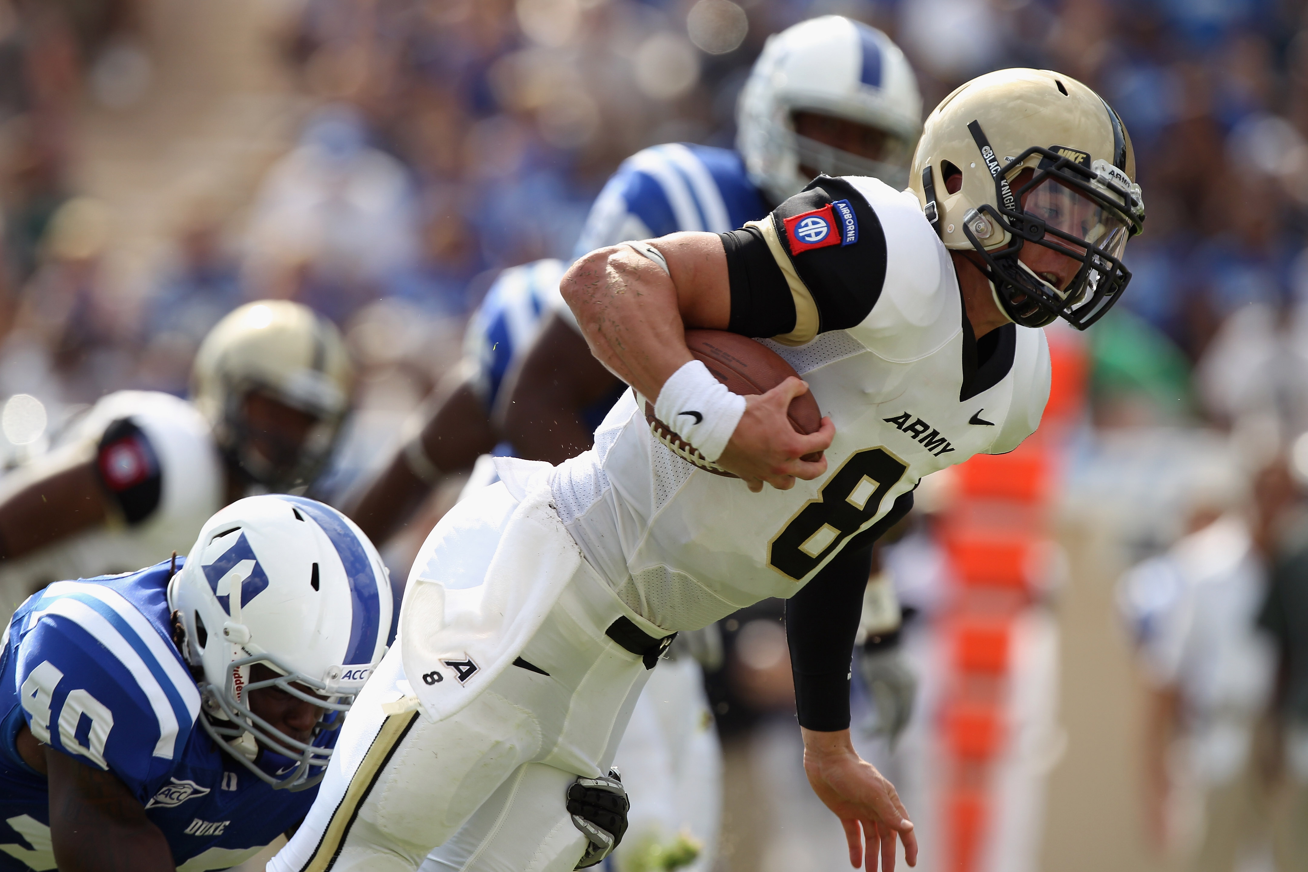 DURHAM, NC - SEPTEMBER 25: Trent Steelman #8 of the Army Black Knights is tackled from behind by Matt Daniels #40 of the Duke Blue Devils at Wallace Wade Stadium on September 25, 2010 in Durham, North Carolina. (Photo by Streeter Lecka/Getty Images)
