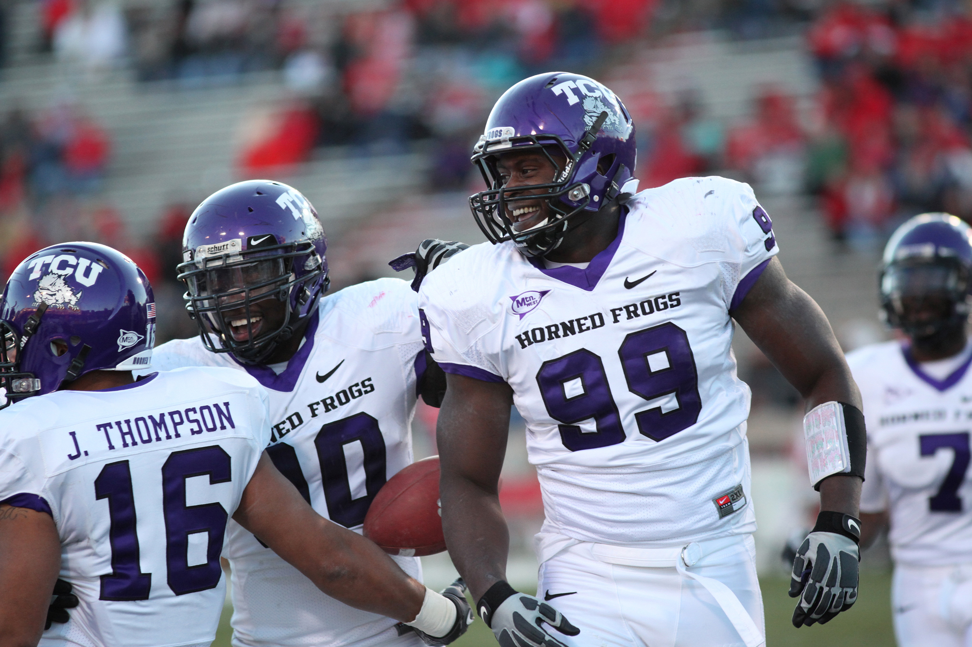 ALBUQUERQUE, NM - NOVEMBER 27: Braylon Broughton #99, Stansly Maponga #90 (C) and Jurell Thompson #16 of the TCU Horned Frogs celebrate after a touchdown against the University of New Mexico Lobos on November 27, 2010 at University Stadium in Albuquerque,