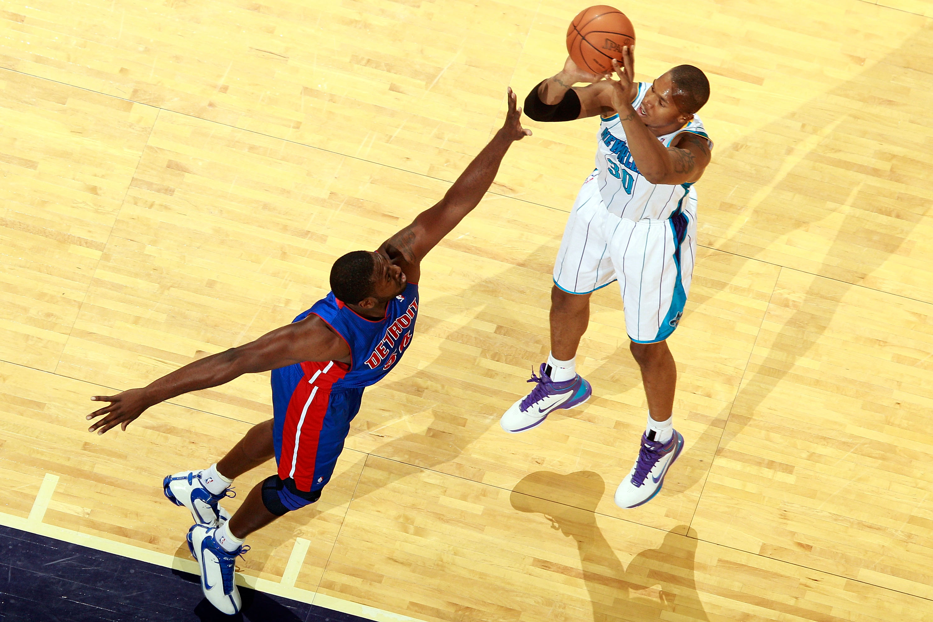 NEW ORLEANS, LA - DECEMBER 08:  David West #30 of the New Orleans Hornets shoots the ball over Jason Maxiell #54 of the Detroit Pistons at the New Orleans Arena on December 8, 2010 in New Orleans, Louisiana.  NOTE TO USER: User expressly acknowledges and 